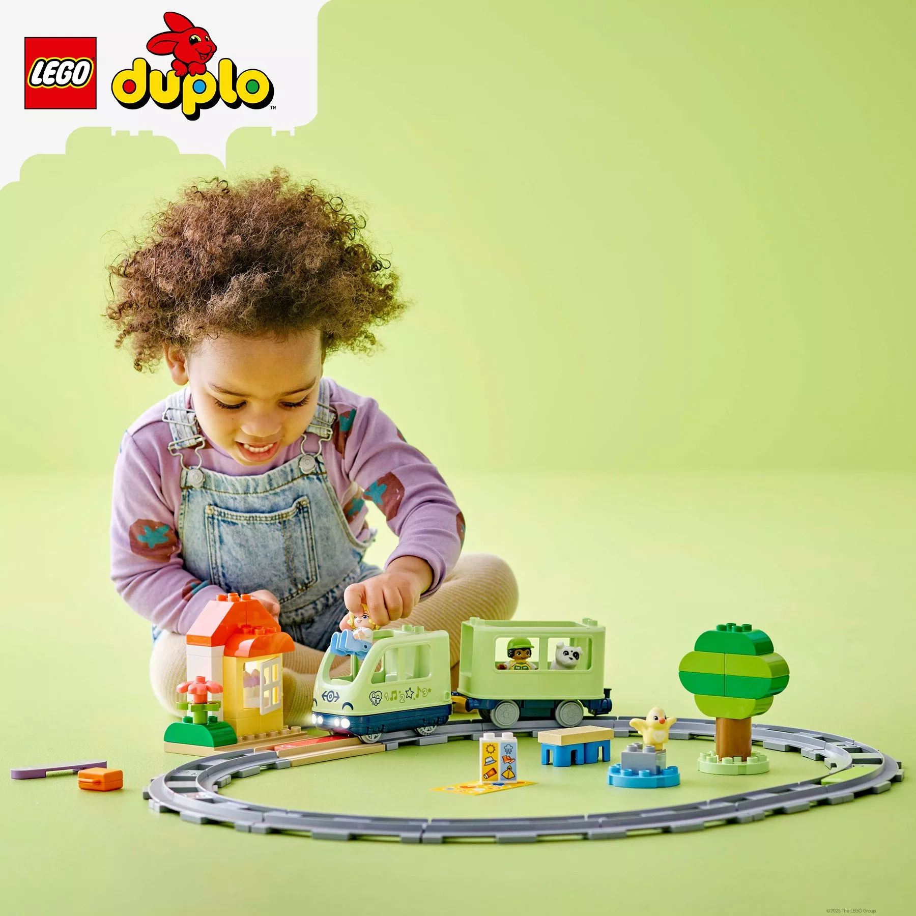Toddler playing with LEGO DUPLO Interactive Adventure Train Building Toy 10427
