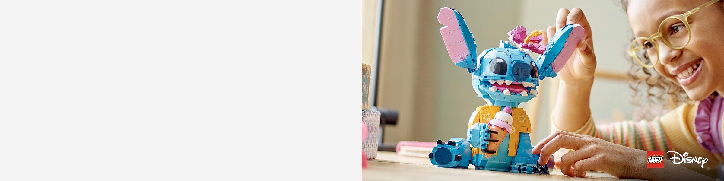 young girl is playing with a colorful LEGO Disney set of beloved blue alien character from Disney's Lilo & Stitch