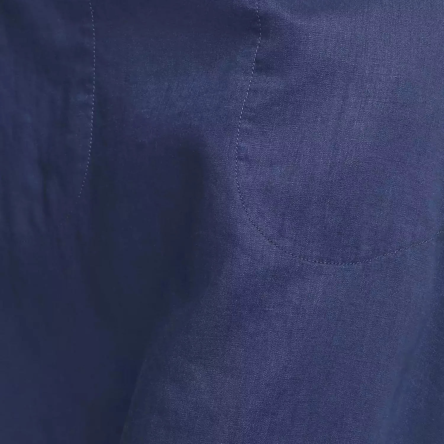 Close-up of navy blue stitched fabric texture with subtle quilting, ideal for bedding or upholstery detail photo