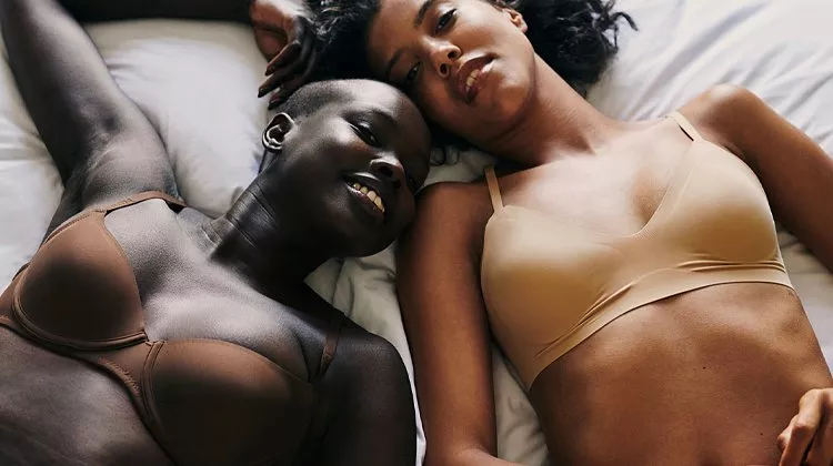 Two women wearing bras