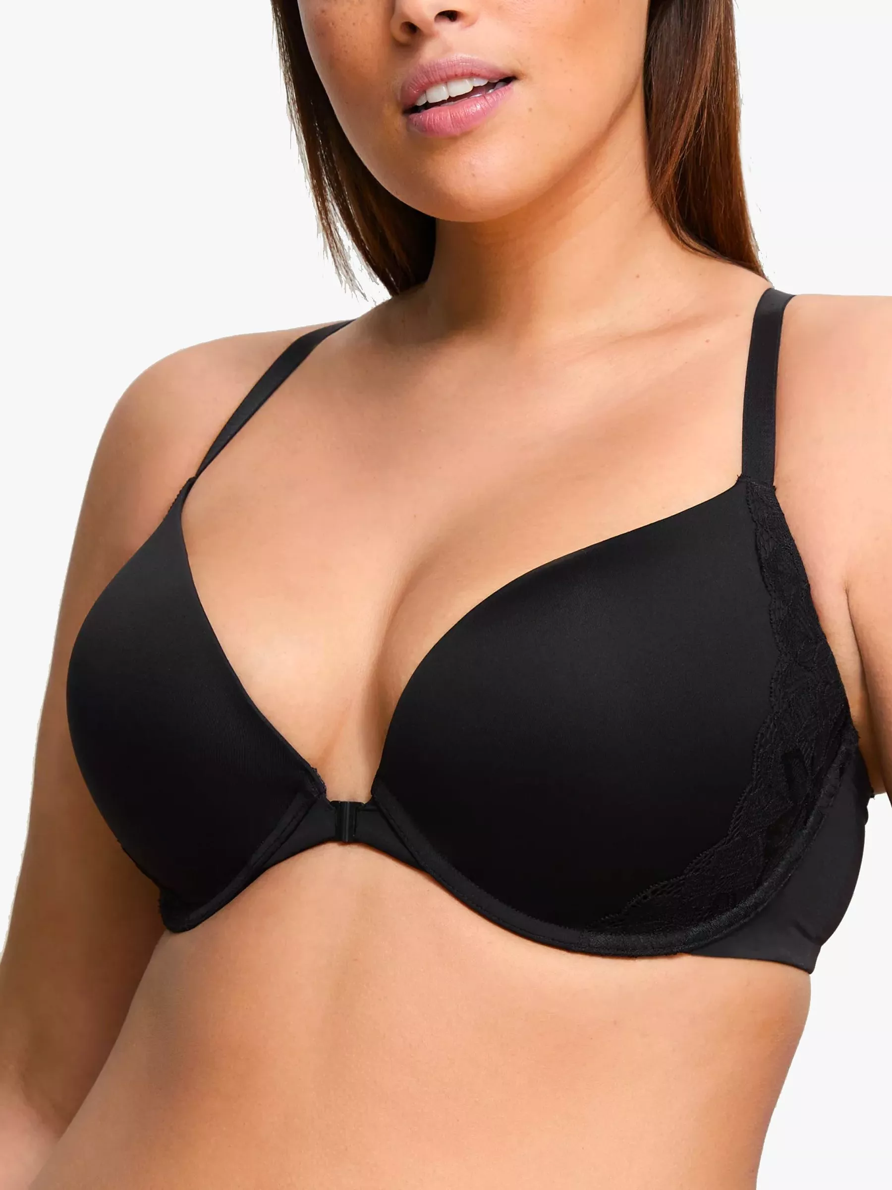 Close-up of model wearing black padded plunge bra with lace side panels, supportive fit on white background