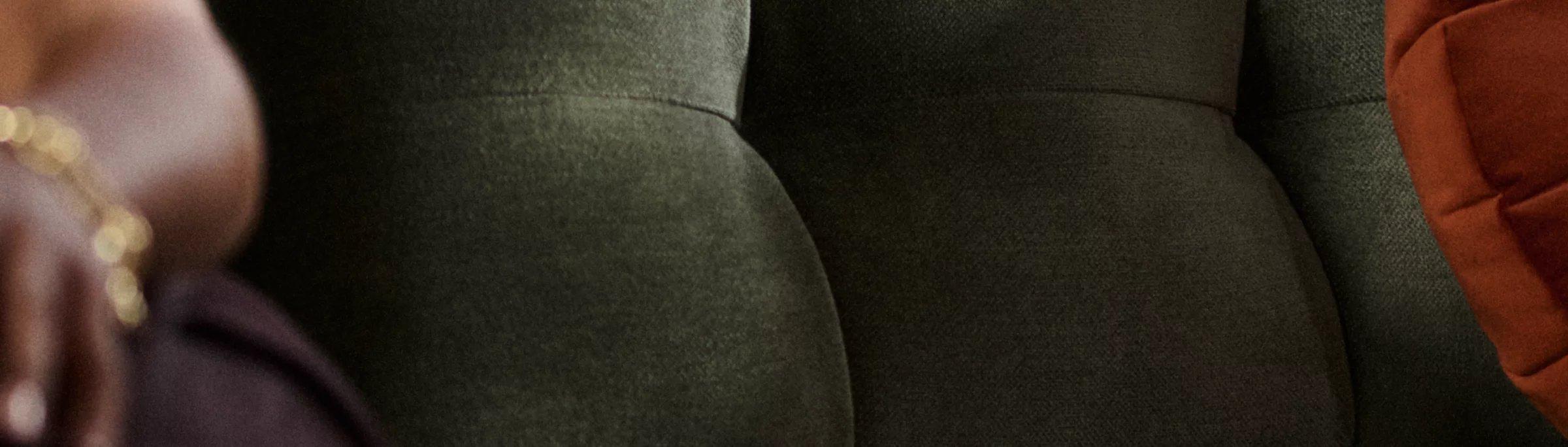 Image of a close up of someone sitting on a sofa