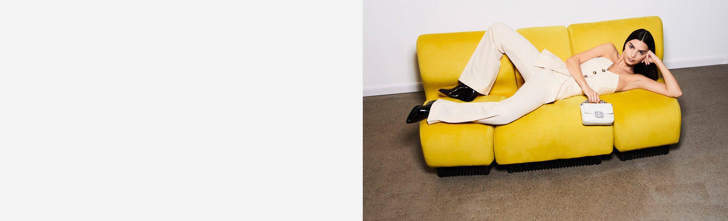 Woman laying on yellow sofa