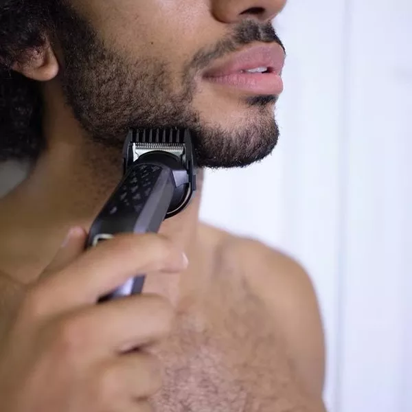 Man using electric razor