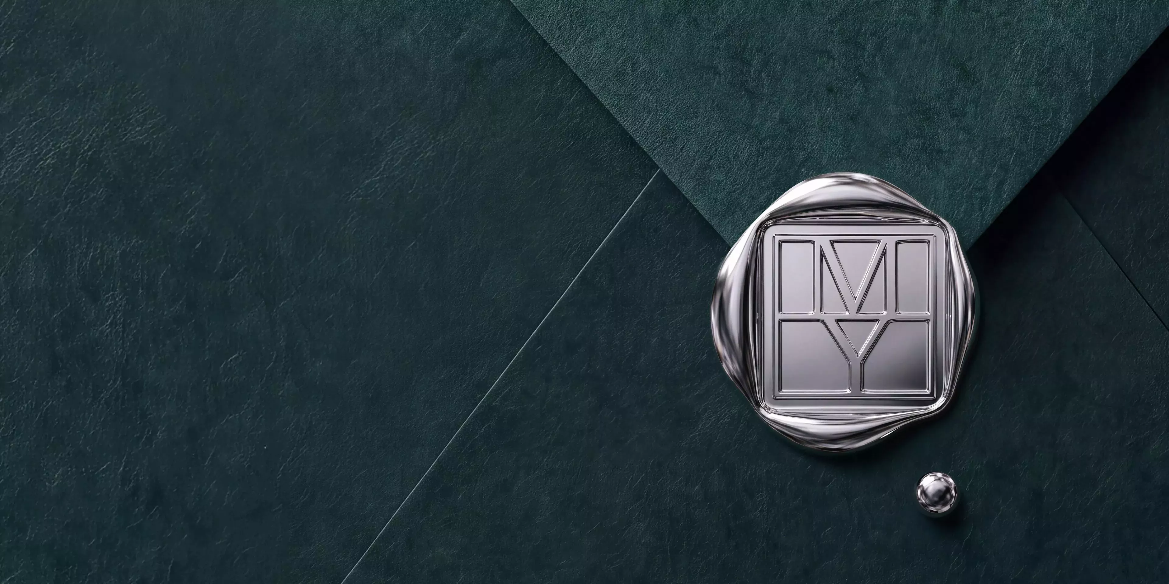 Chrome wax seal with geometric monogram on dark teal textured paper, luxury stationery branding mock-up