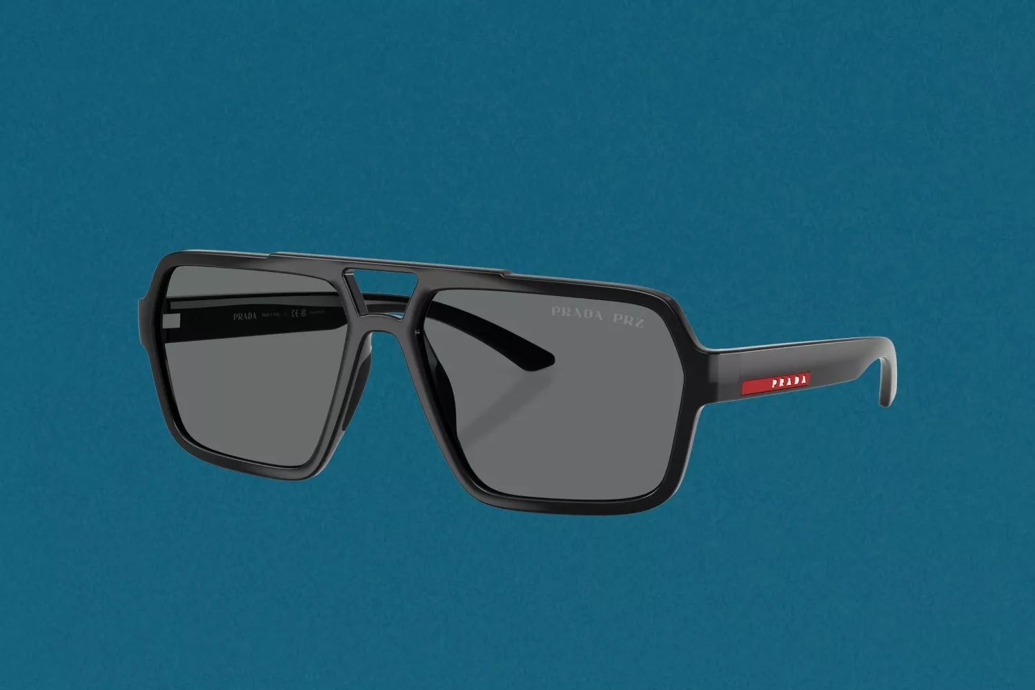 Black Prada Linea Rossa sunglasses with grey lenses and red logo detail on arms
