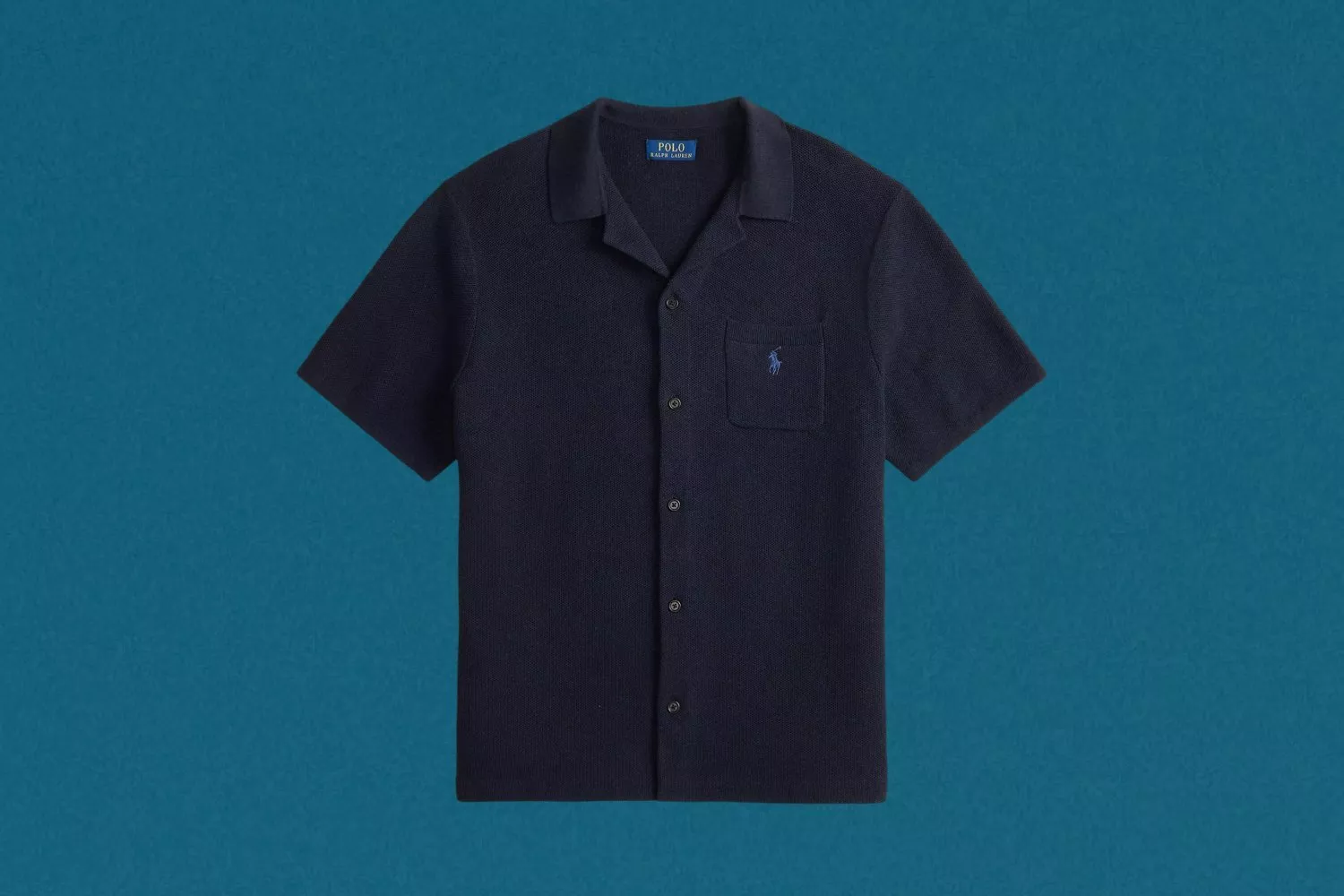 Navy short-sleeve button-up polo shirt with chest pocket and embroidered logo on blue studio background