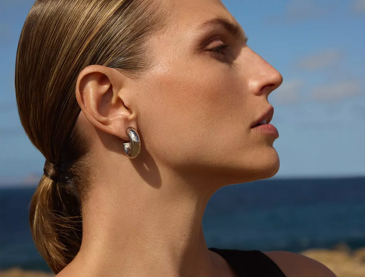 Model at the beach wearing minimalist make up