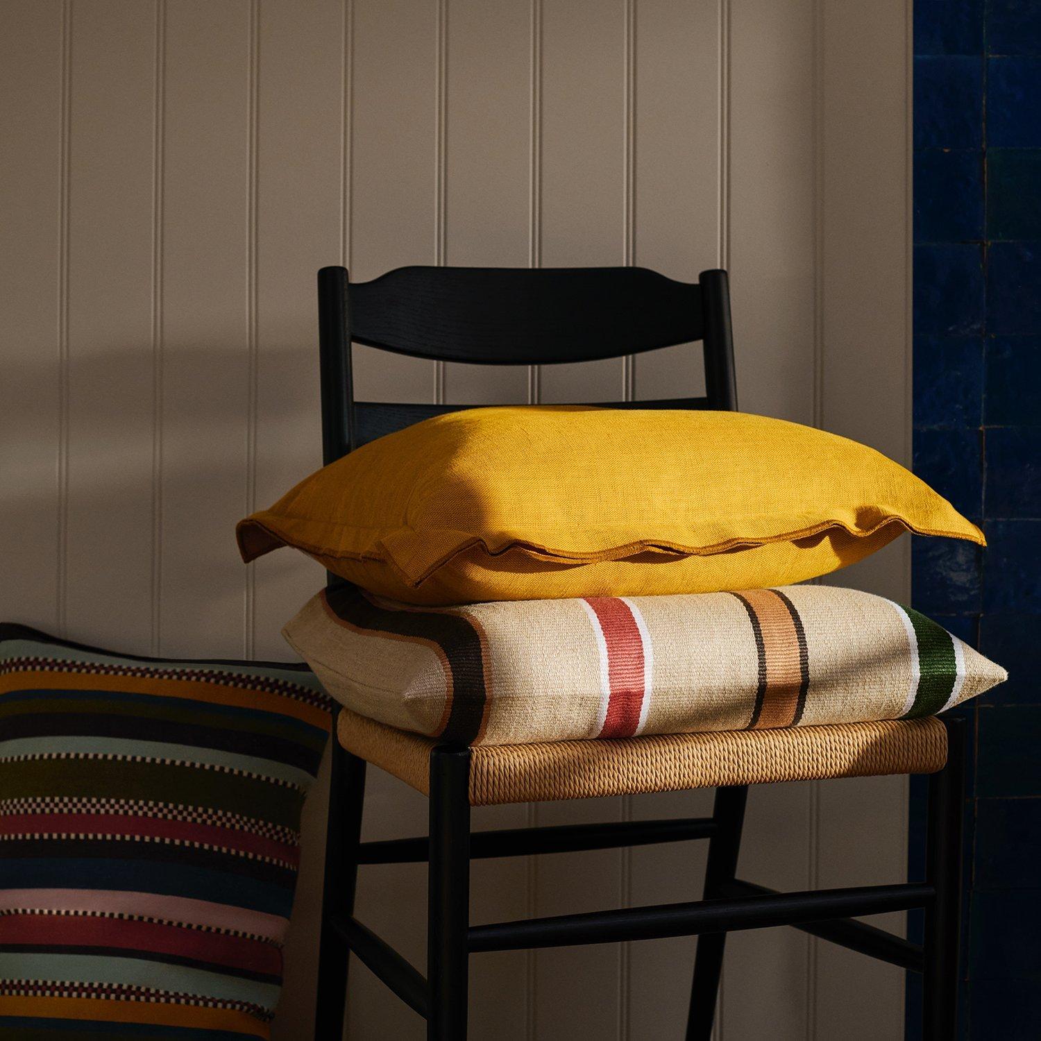 a bright yellow cushion on a chair