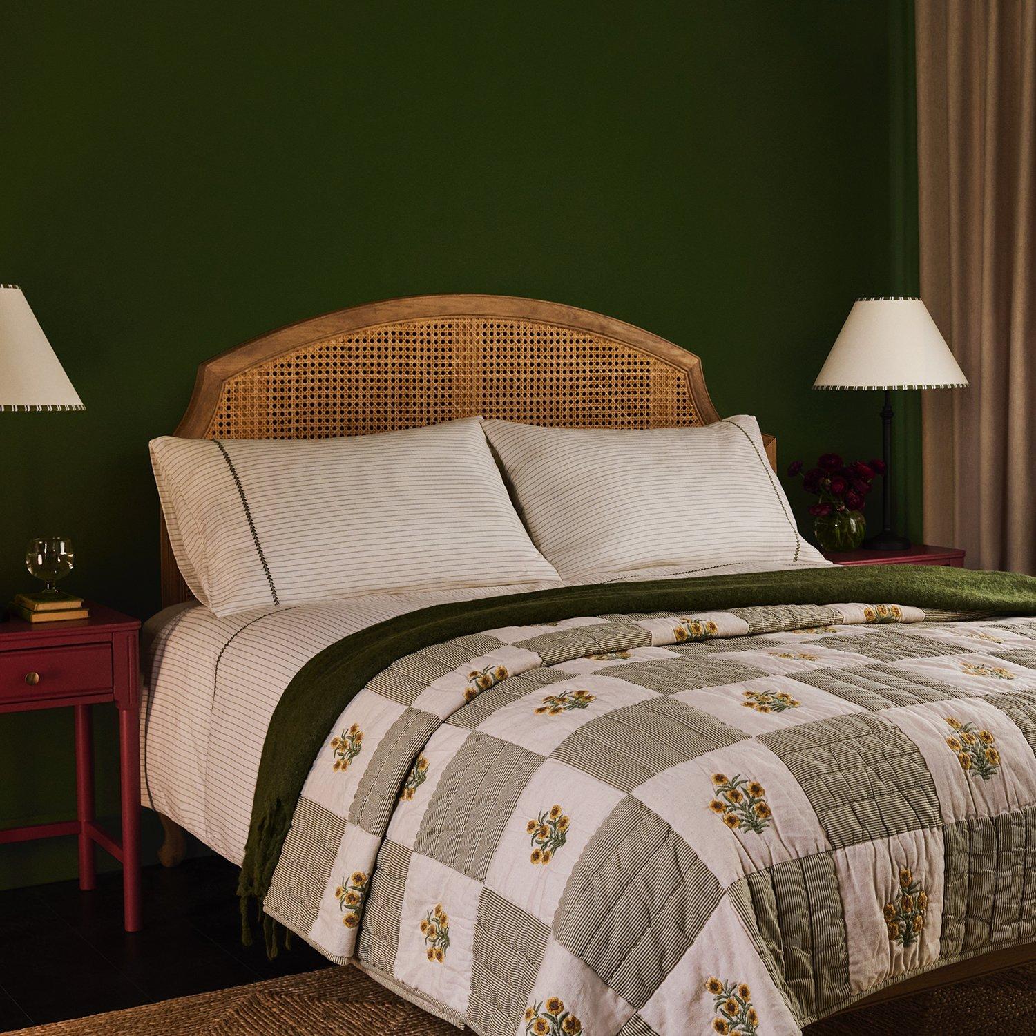 a bedroom room set with a floral throw