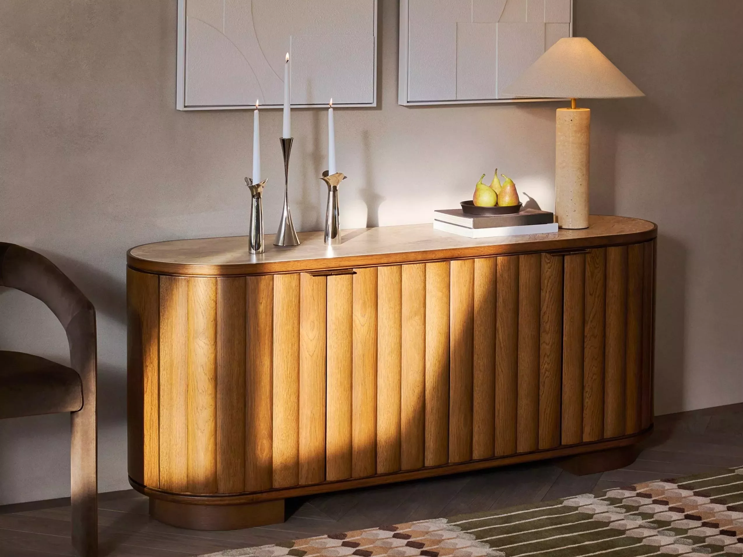 Modern bedroom interior with upholstered bed, rust quilt, bedside lamps, abstract wall art and wooden sliding door