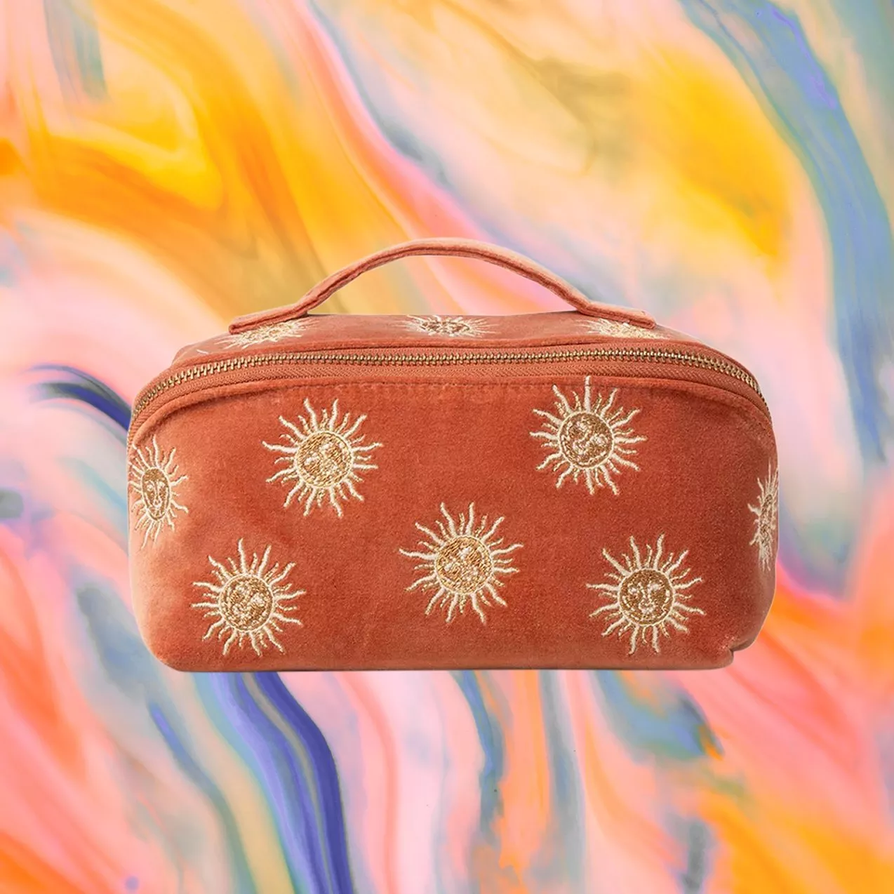 Rust-coloured pouch adorned with sun motifs, set against a vibrant, swirling background of yellow, pink, and blue.