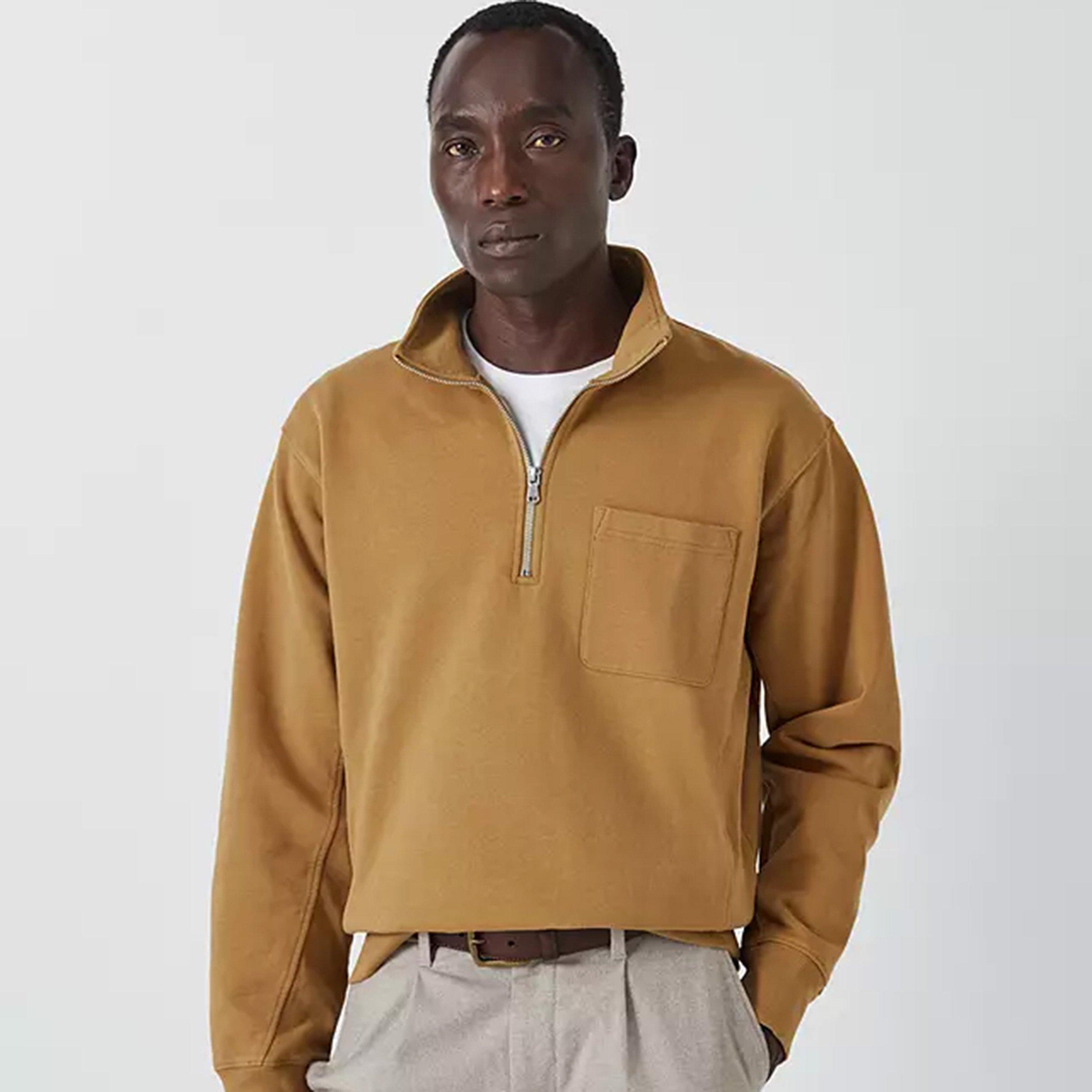 Man wearing mustard zip neck jumper