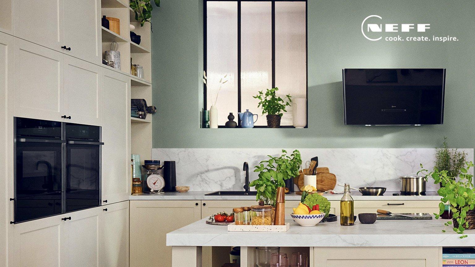 stylish, modern NEFF kitchen appliances, oven, hood in a sage green wall and white cabinetry kitchen