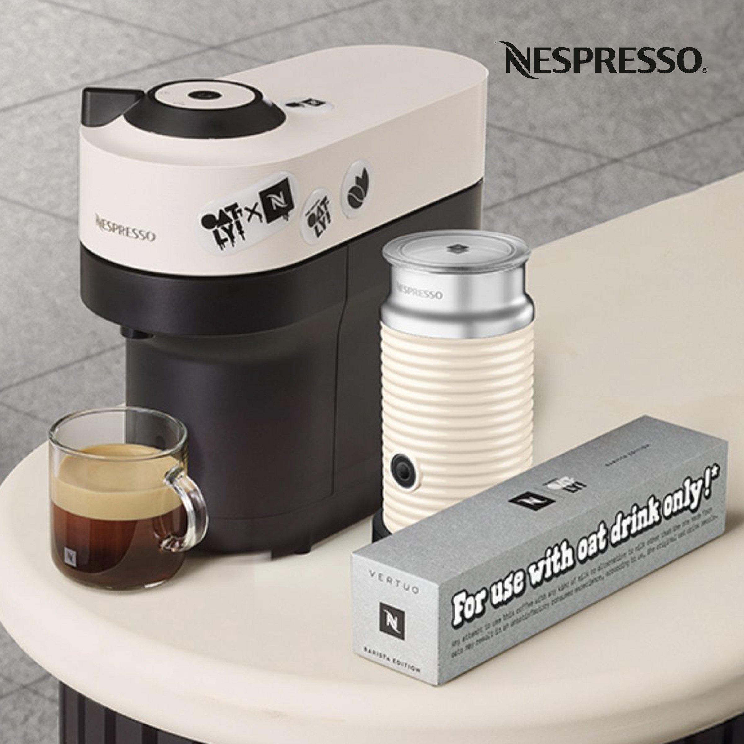 nespresso coffee machine on a table with milk machine and mug