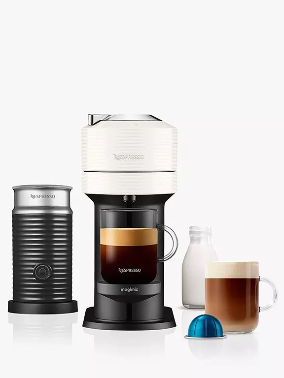 Vertuo Next machine with separate milk frother and coffee in a glass mug