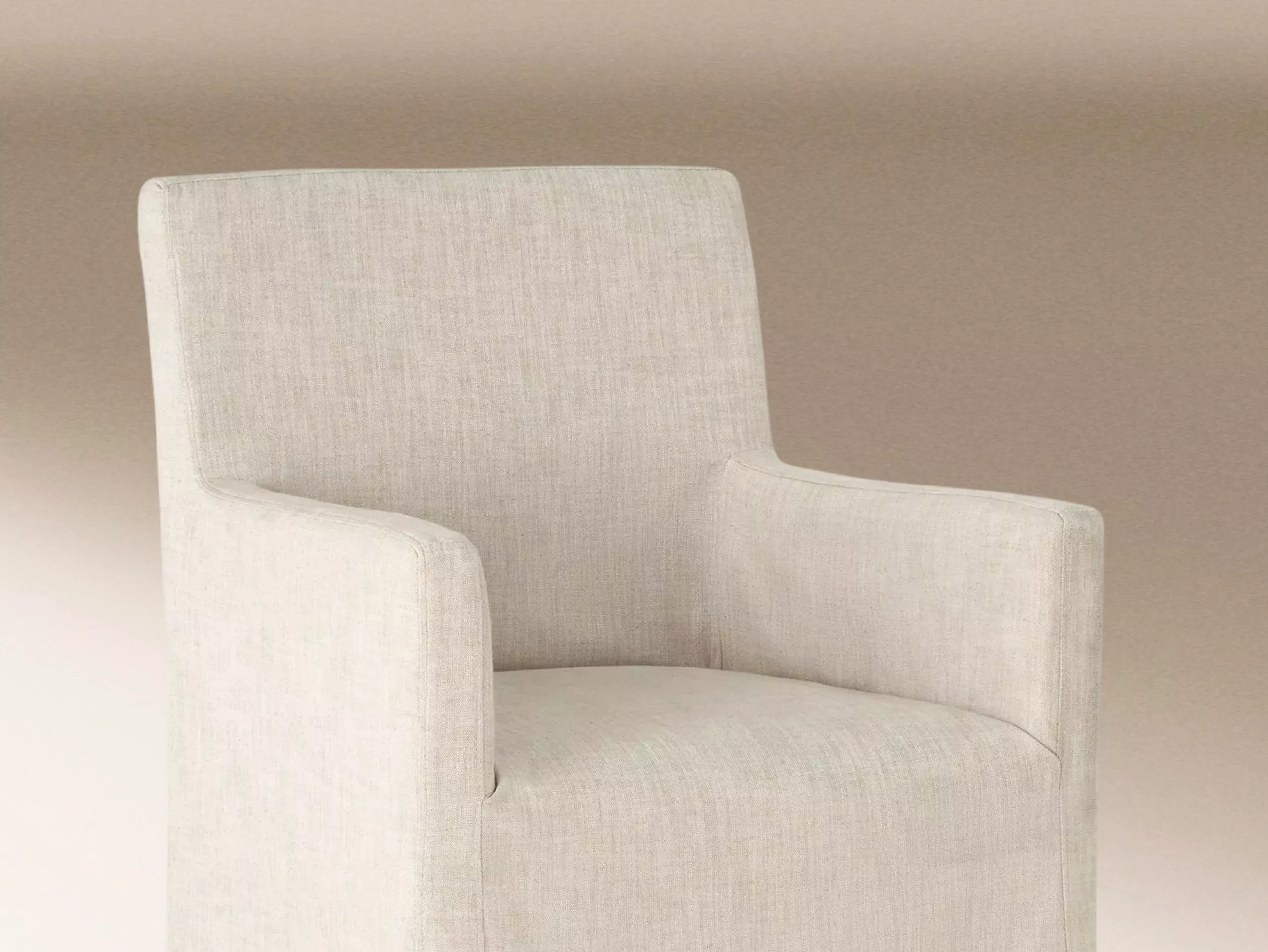 Modern beige armchair with clean lines, upholstered in textured fabric, set against a neutral gradient background.