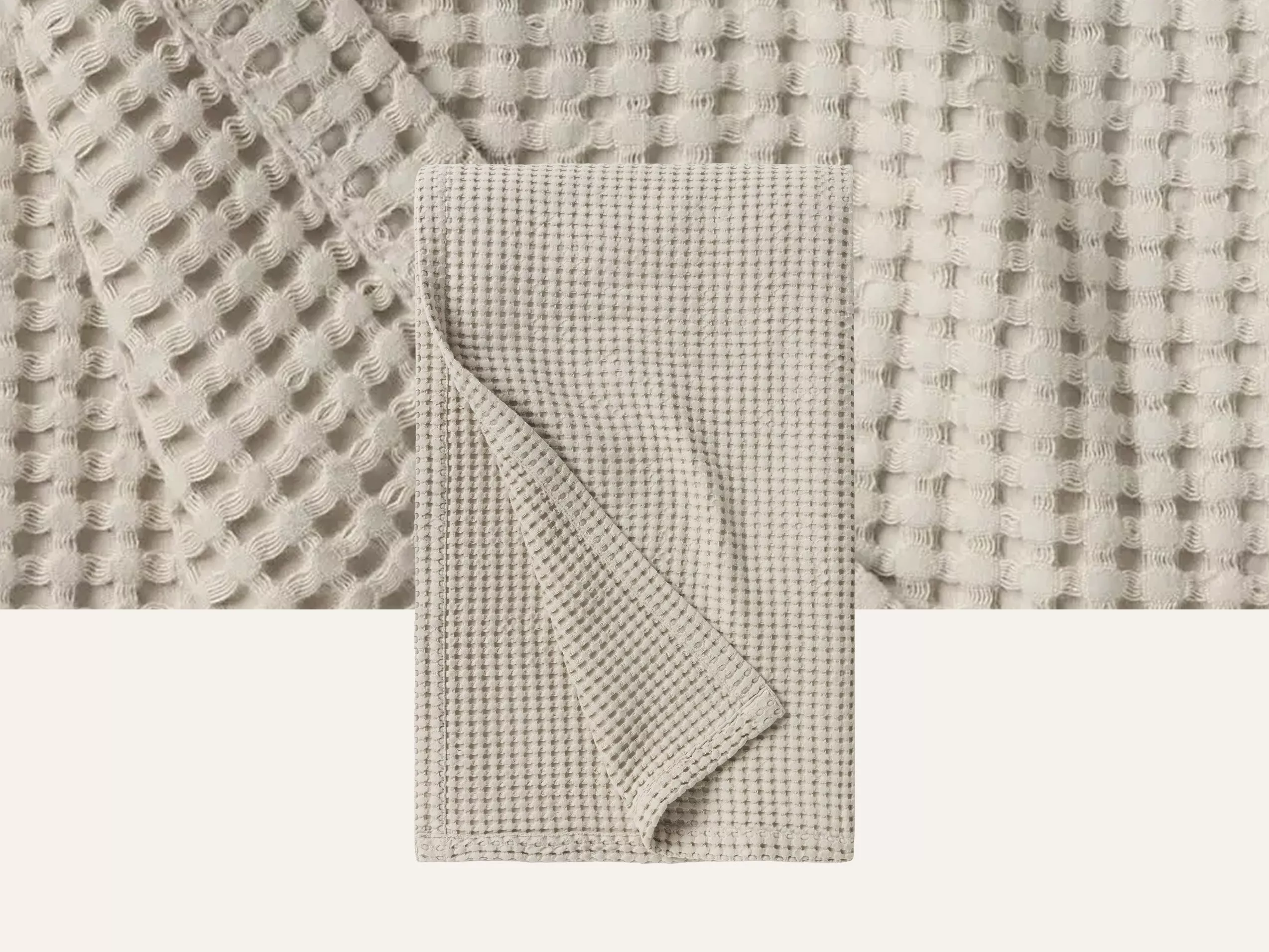 Close-up of a beige waffle-knit fabric, showcasing texture and pattern, with a folded section in front.