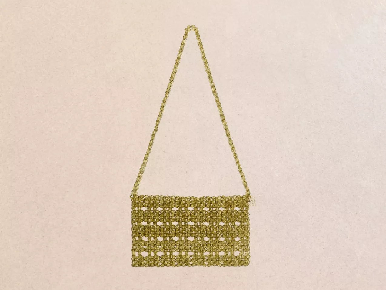 Golden faux pearl handbag with a shoulder strap, with an open-weave design.