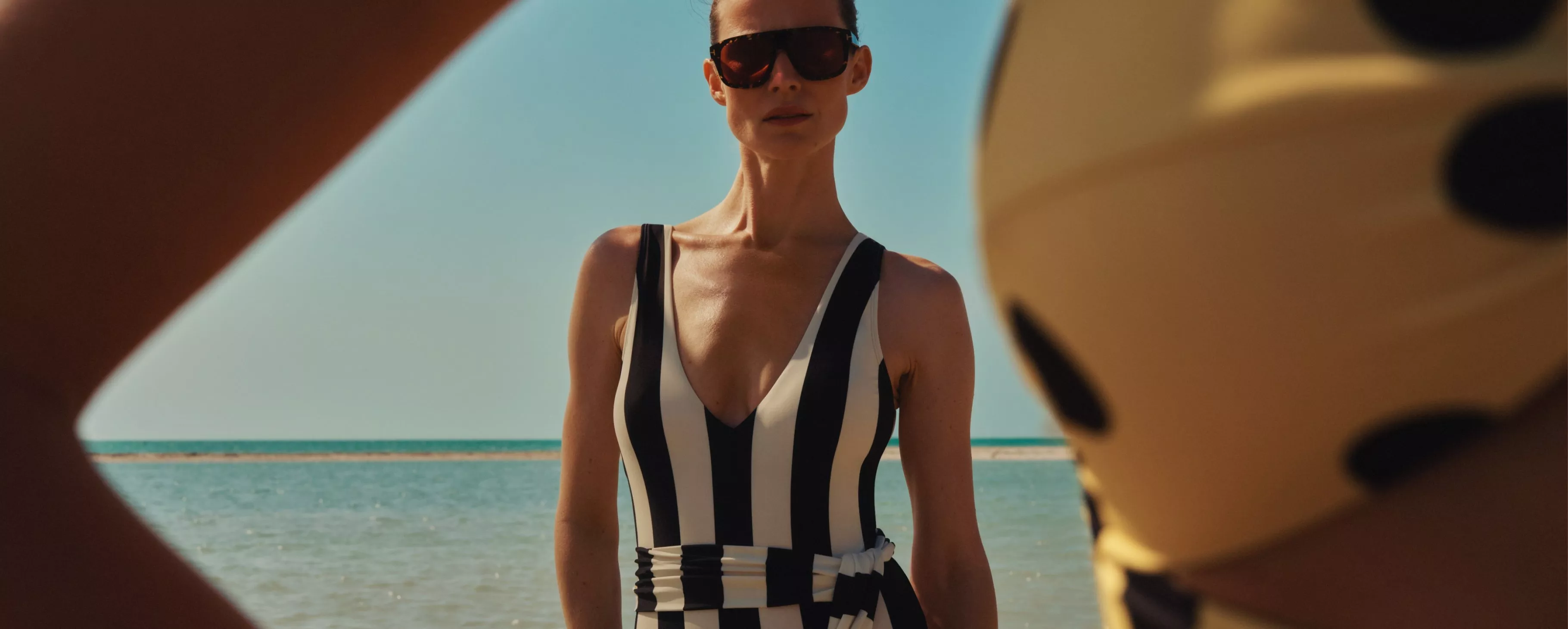 women wearing a stripe swimming costume