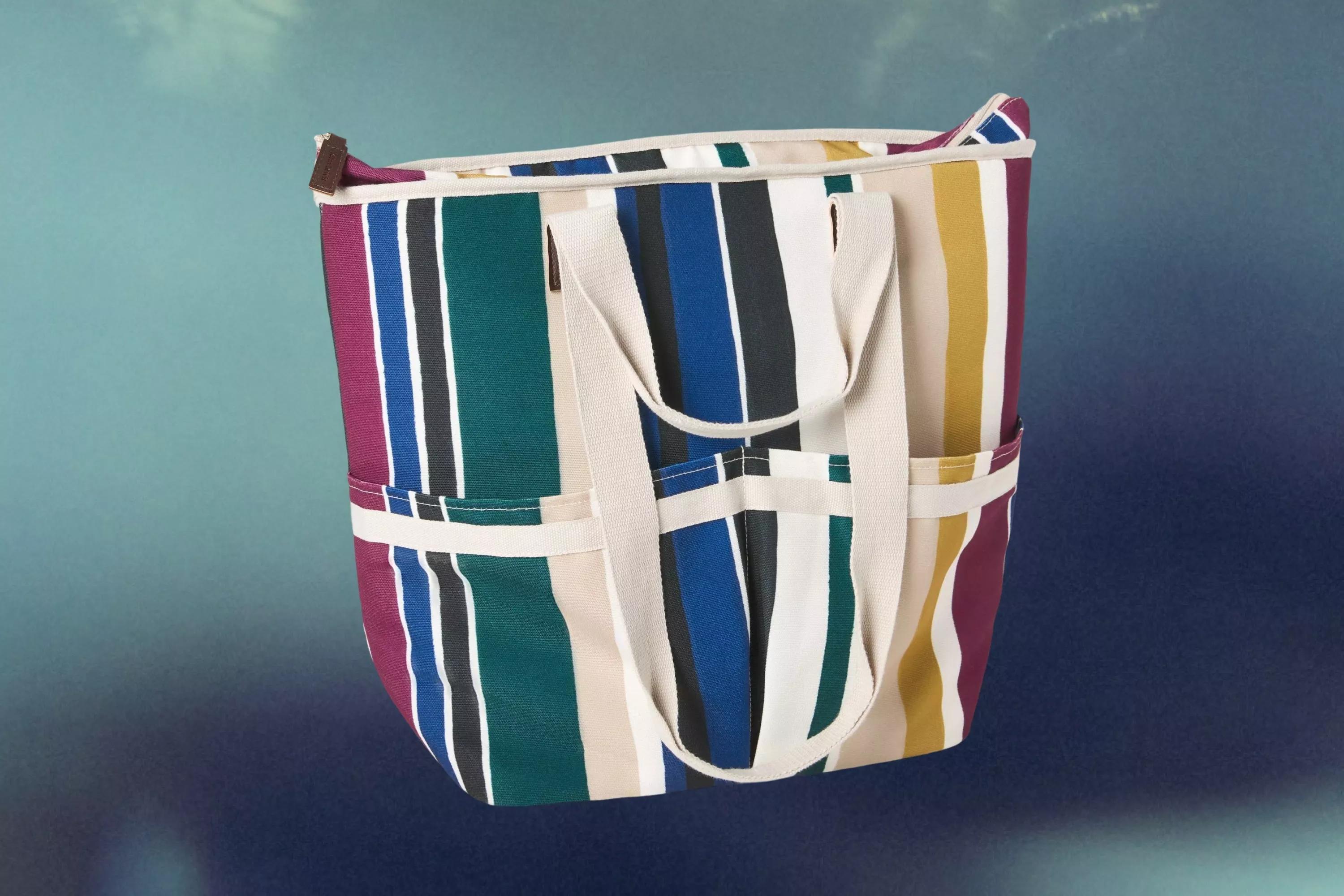cut out of a John Lewis Modern Rustic Stripe Picnic Cooler Bag on a hazy blue background