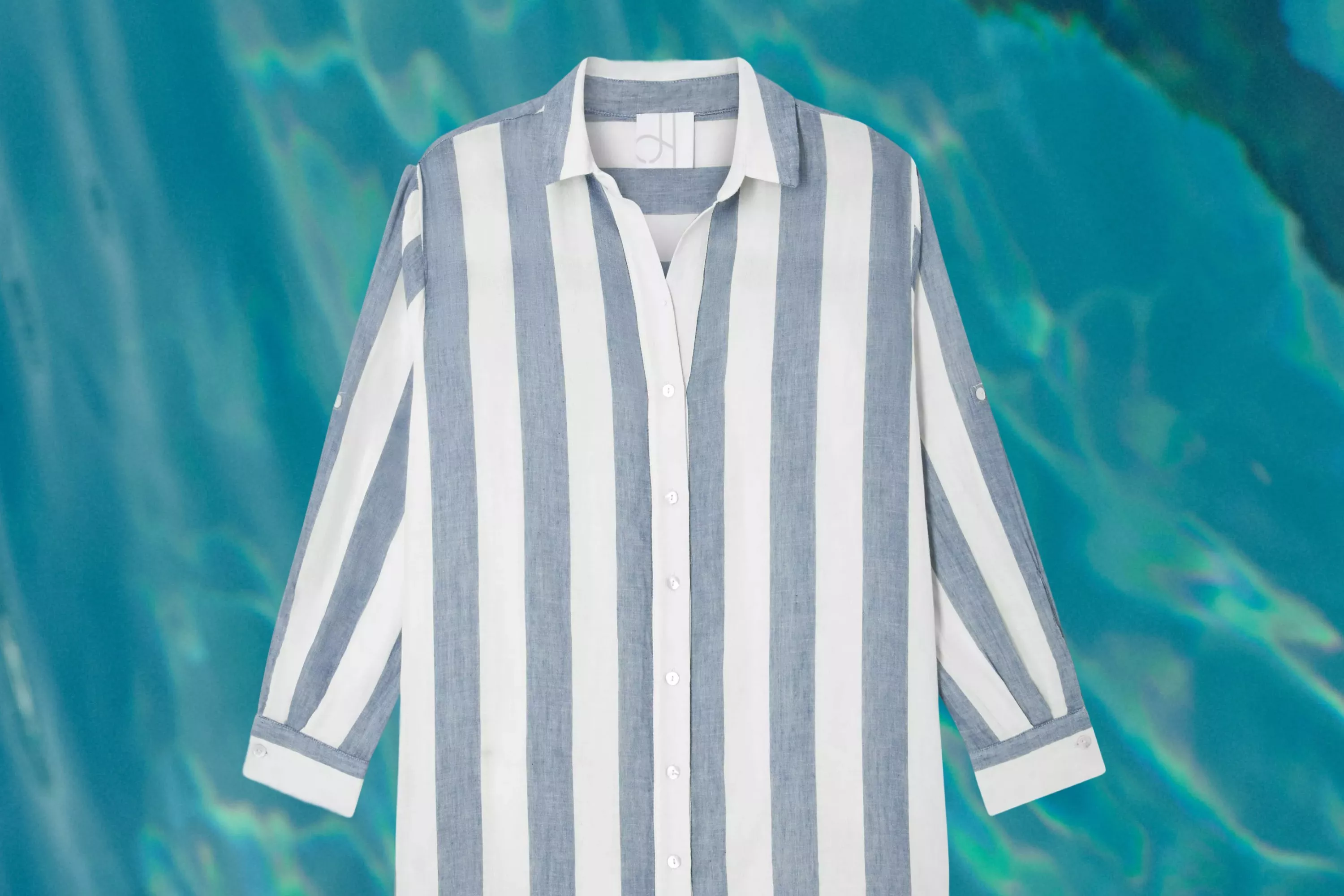 cut out of a John Lewis Cotton Stripe Beach Shirt on a swiming pool background