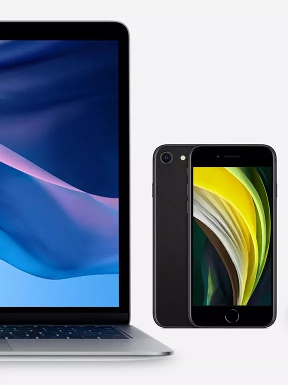 Laptop and smartphone display vibrant abstract wallpapers, illustrating modern technology design aesthetics.