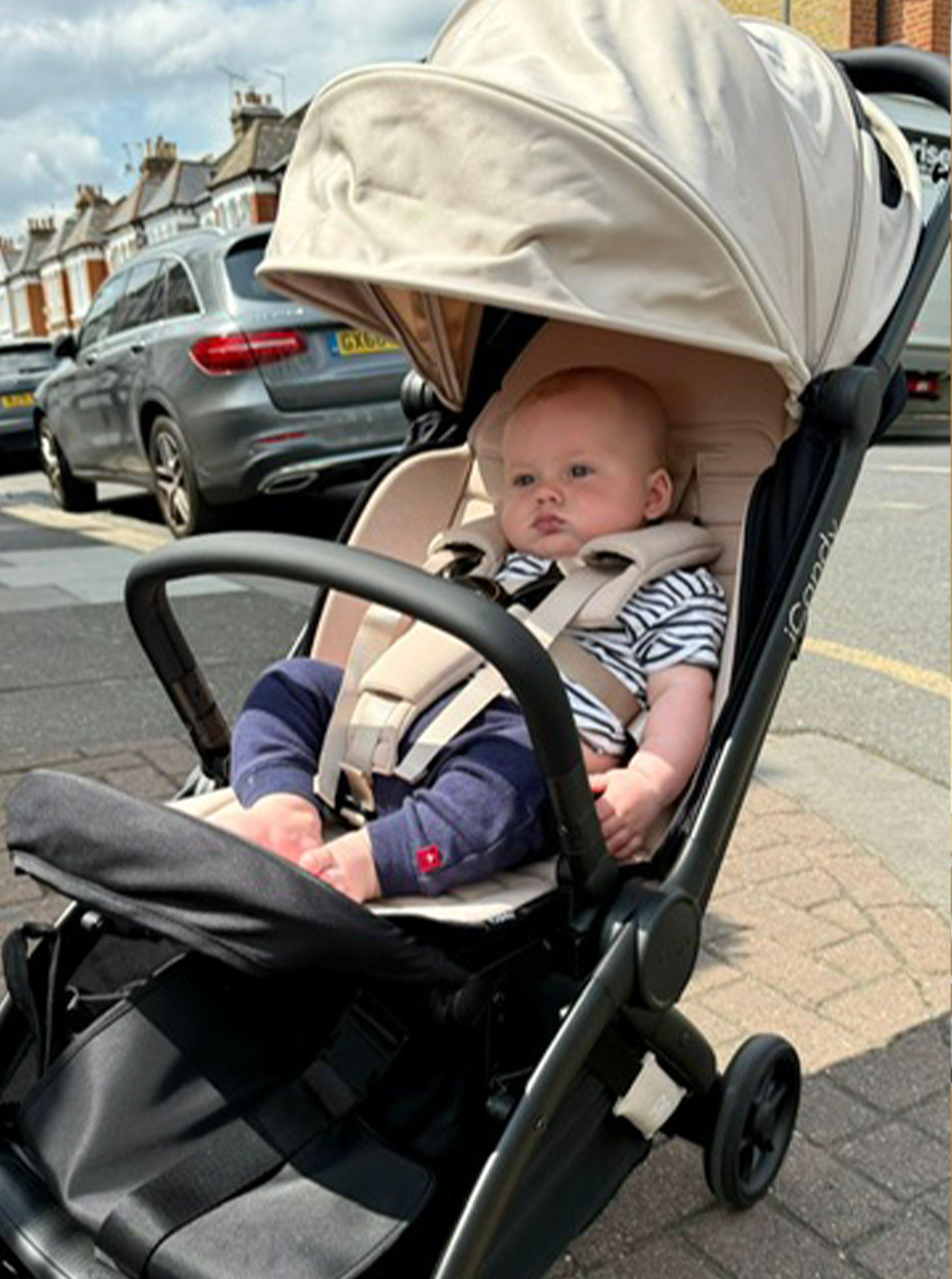 Baby sat in the iCandy PiP Compact Travel Pushchair
