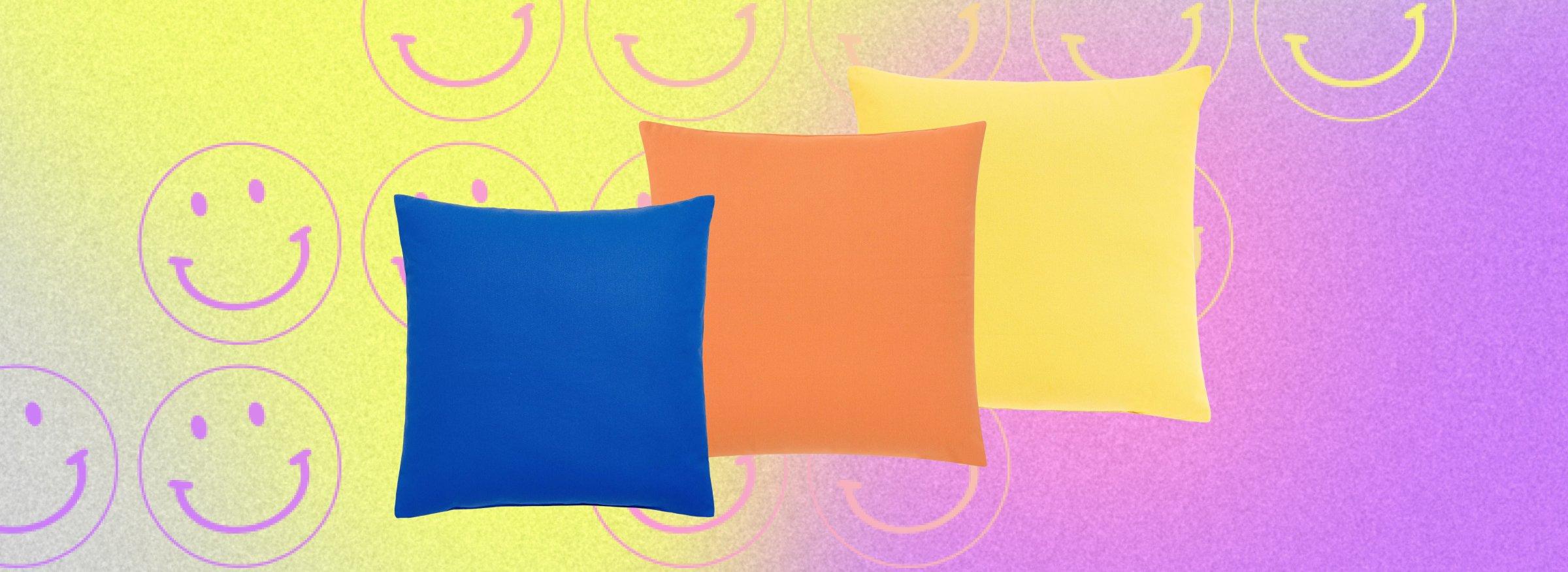 cutout of a bed on a multicolour bacground with smiley faces on it