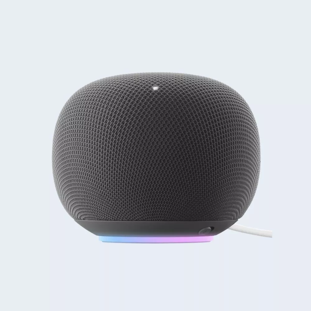 Black smart speaker with textured mesh design, LED light base and power cable, isolated on light background
