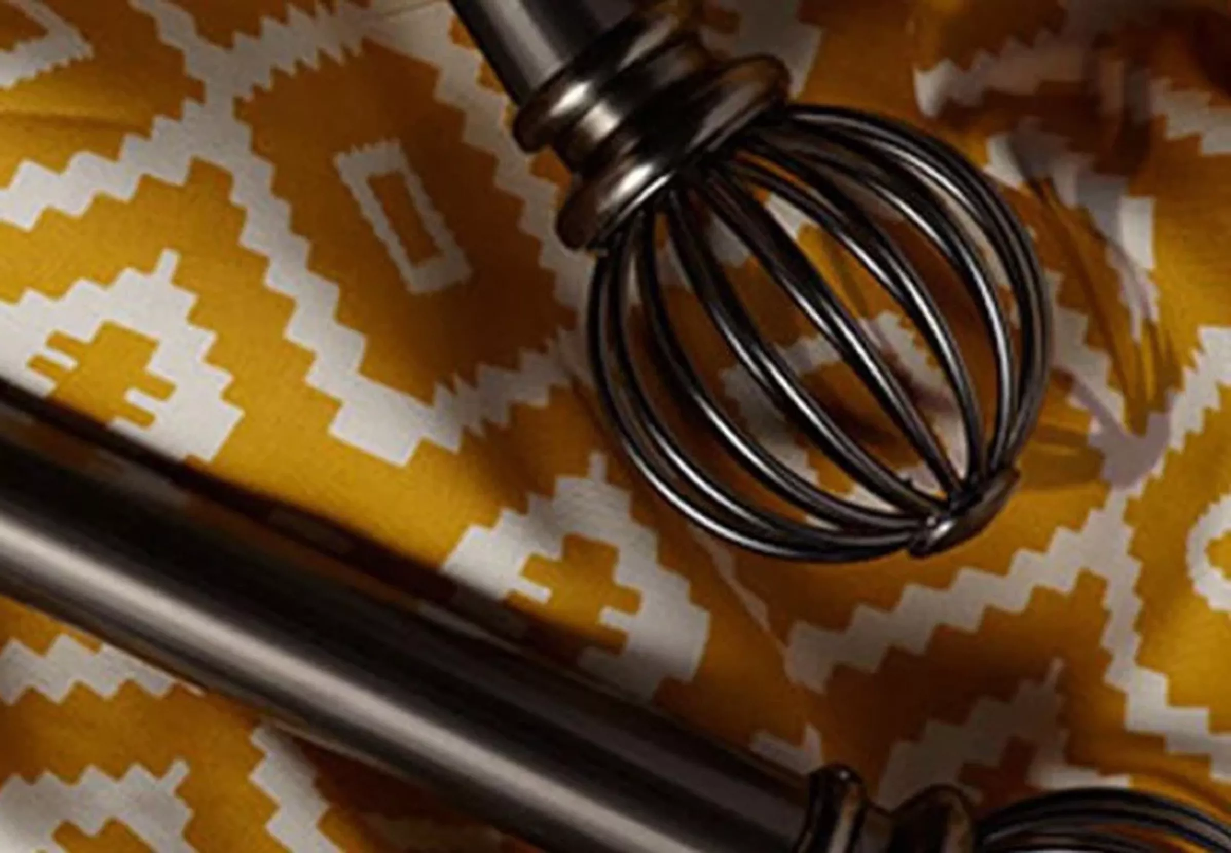 Dark metal curtain pole on yellow and white fabric