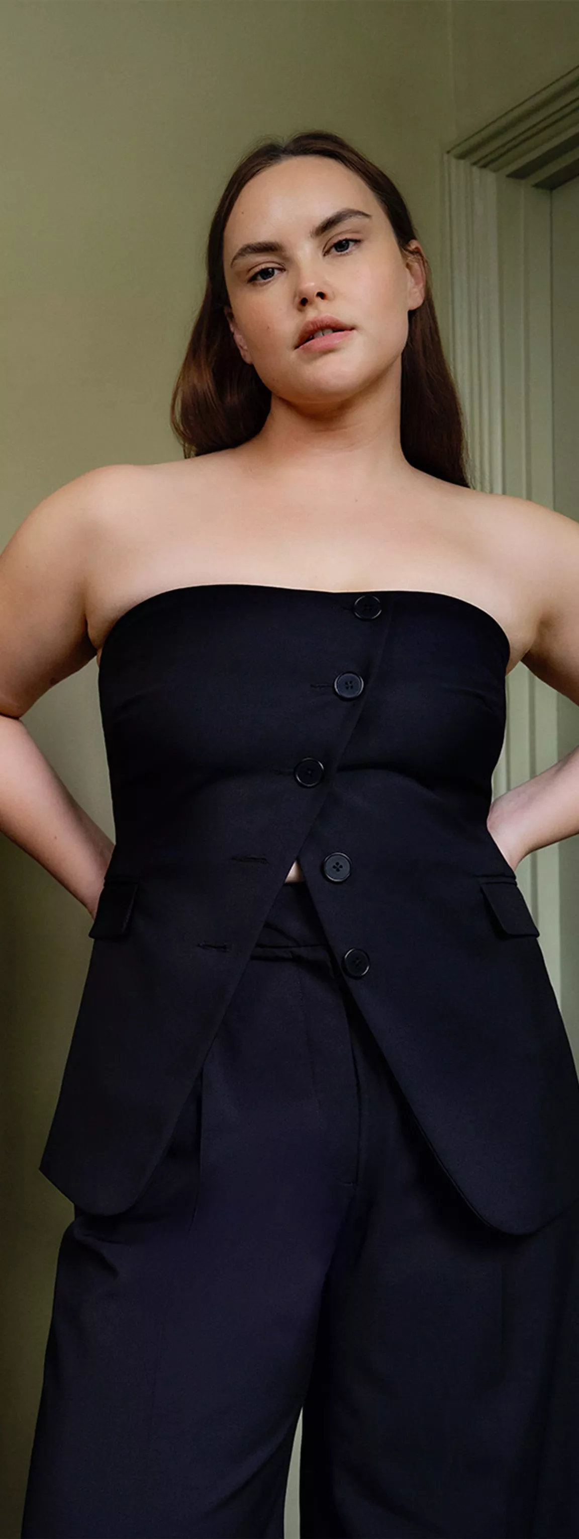 Women in black strapless top and black trousers