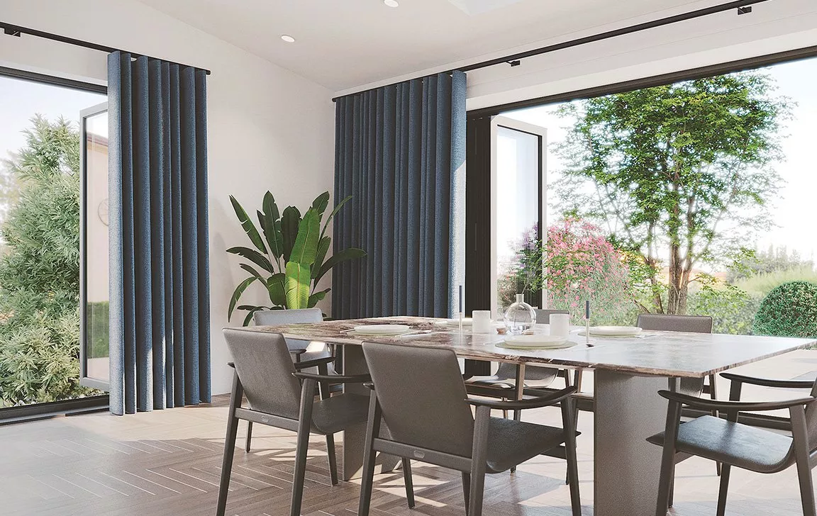 Dining room with patio windows and blue floor length curtain