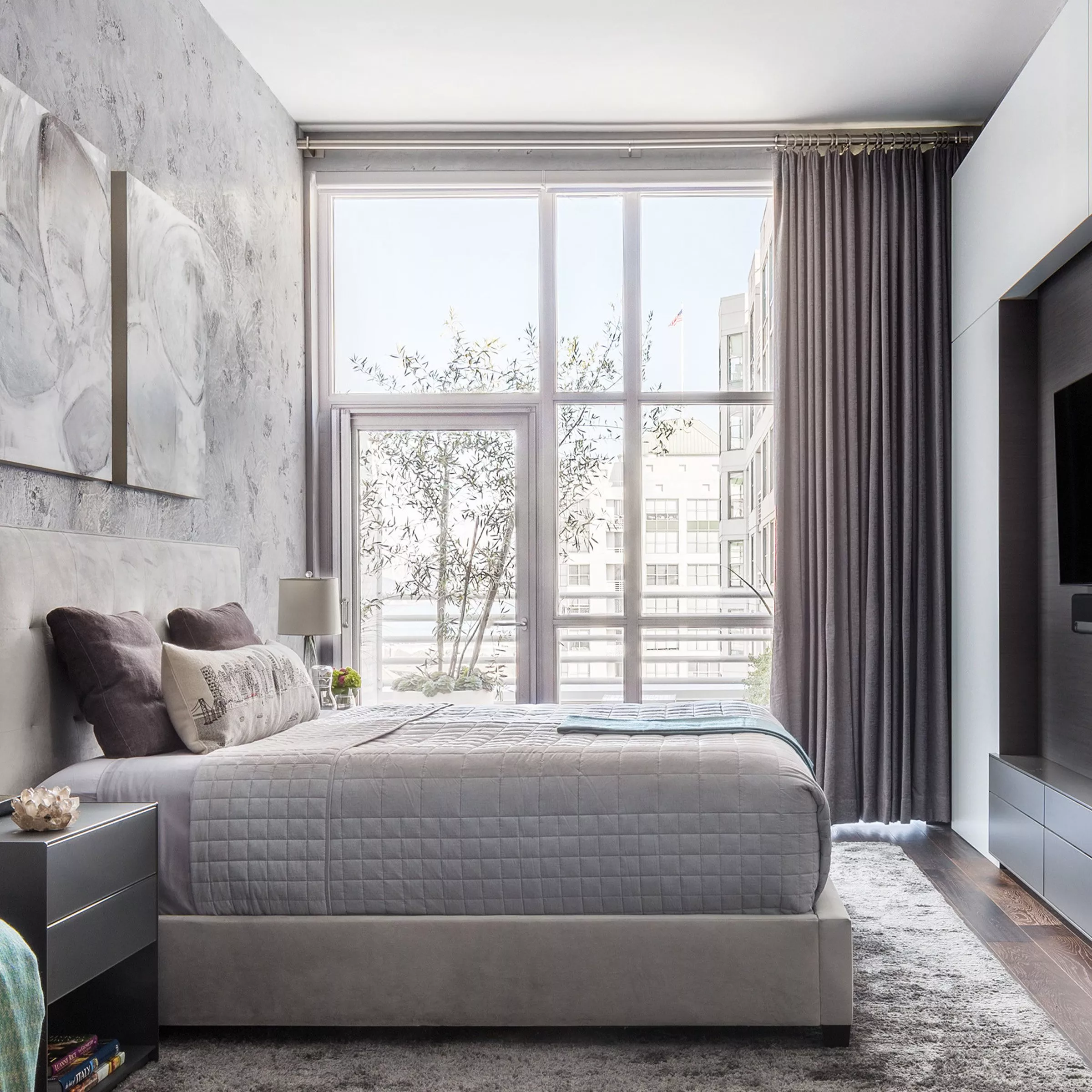 Bedroom with floor to ceiling windows and a grey curtain