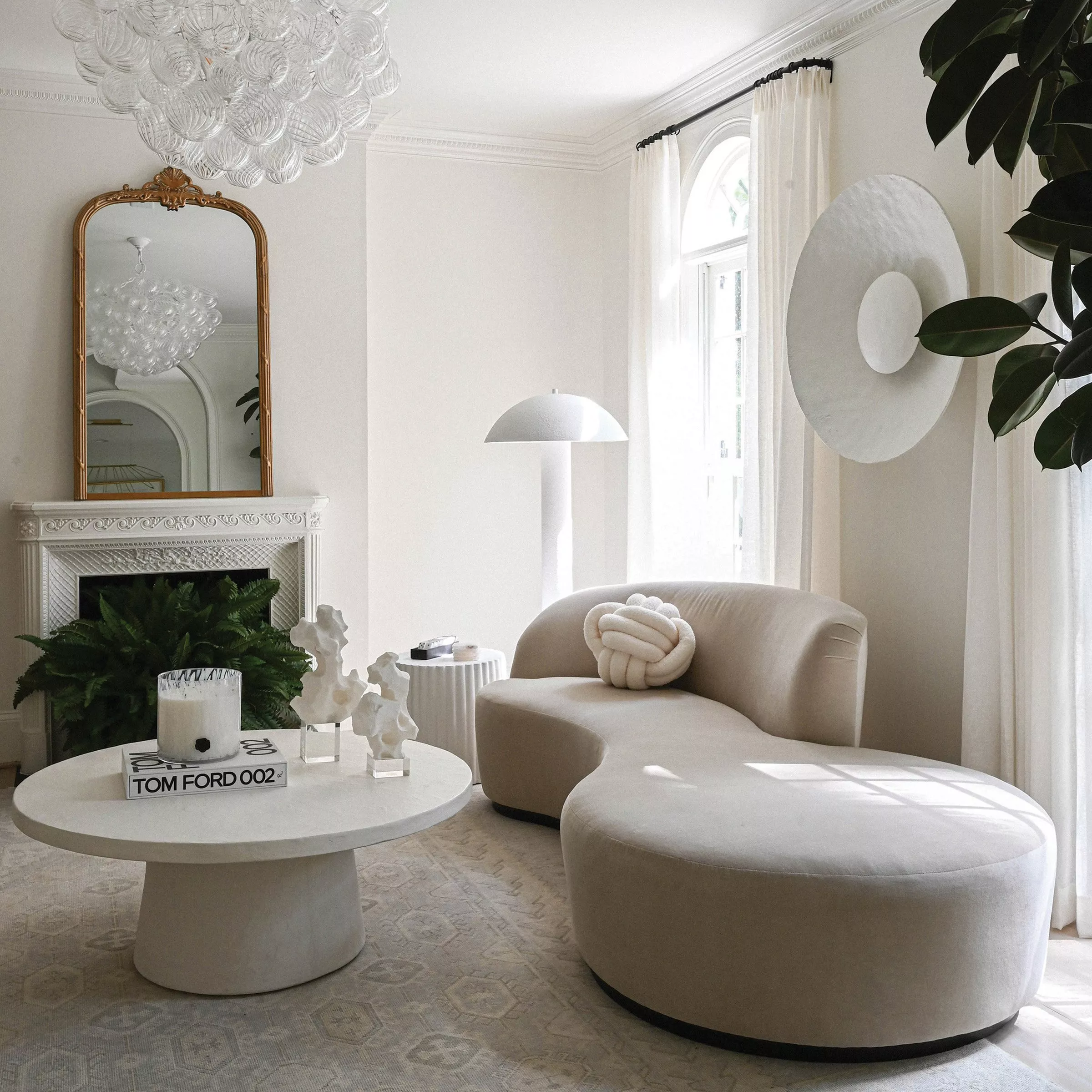 Living room with cream sofa and white sheet curtains 