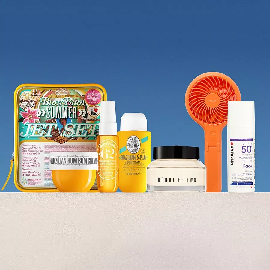 Selection of cosmetic products against a blue sky backdrop