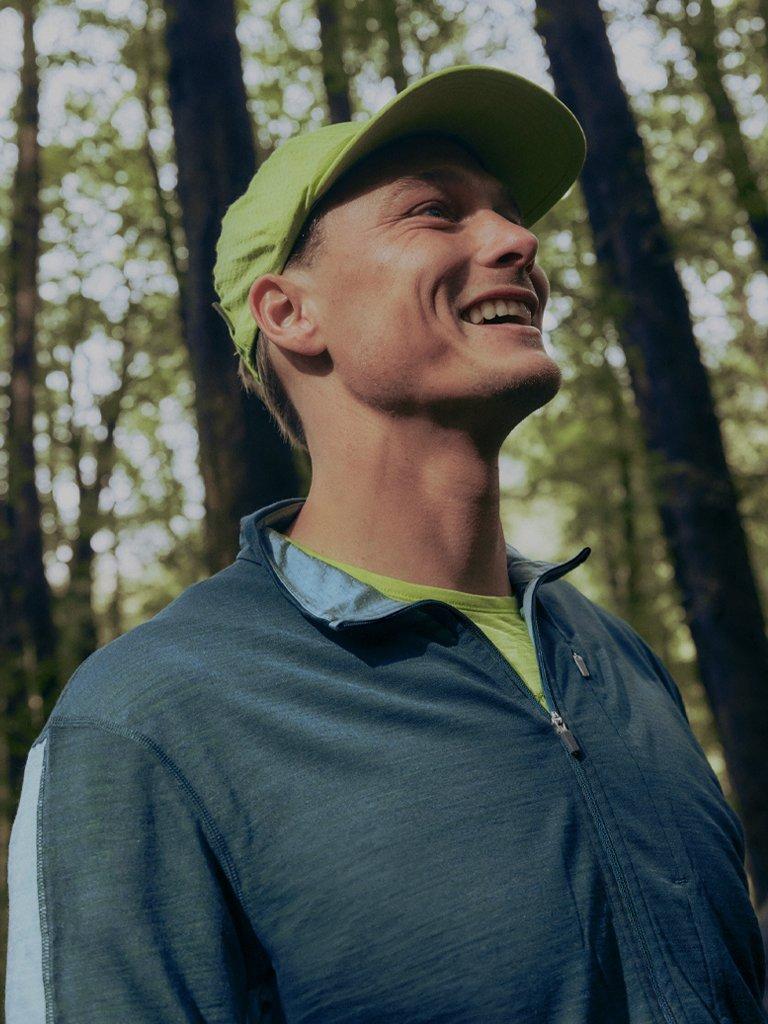 Man wearing icebreaker gear in the forrest