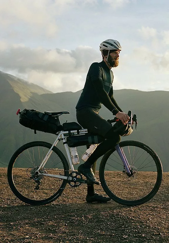 side view of a man on a bicycle