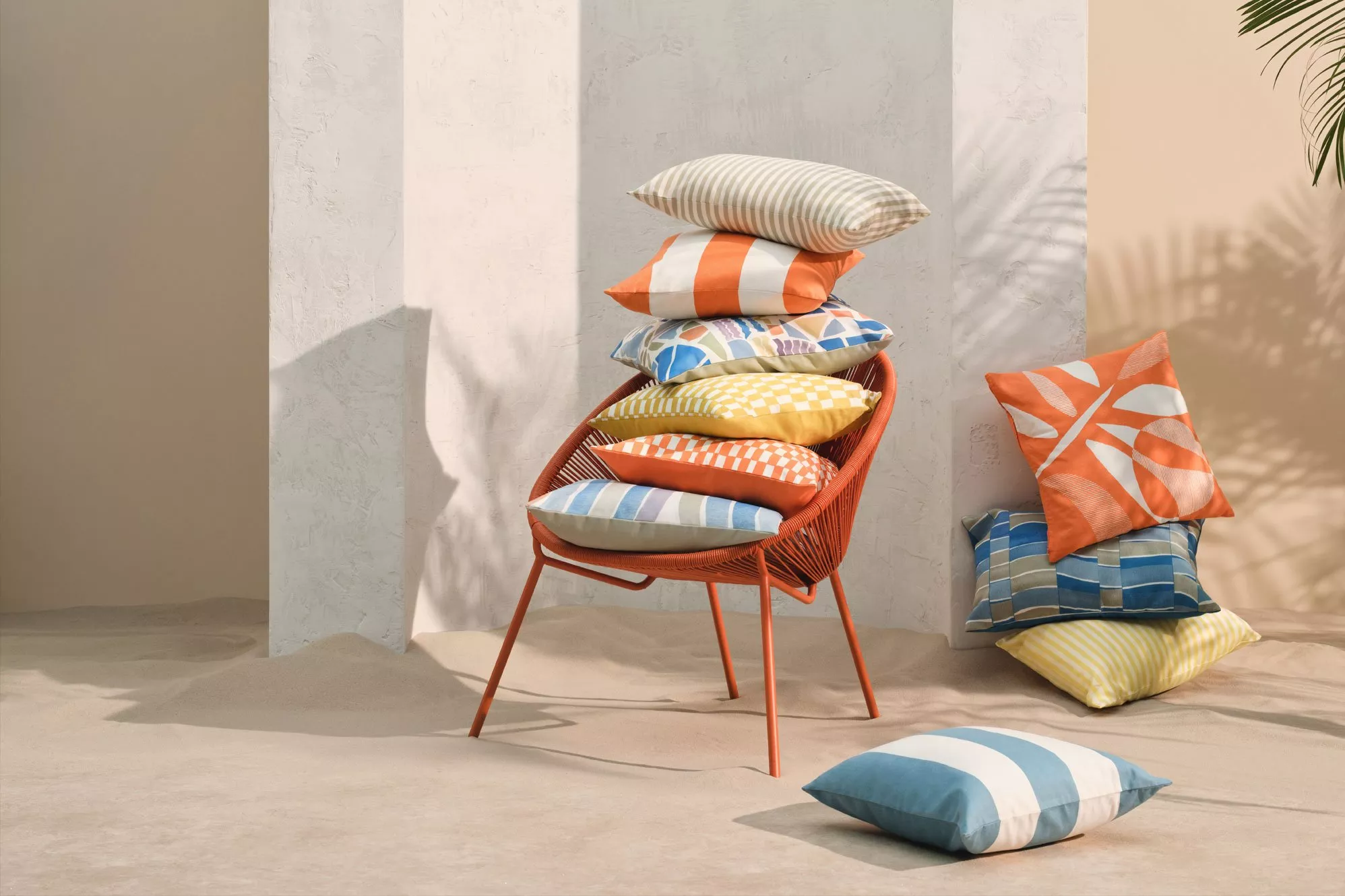 Colourful outdoor cushions on an orange chair