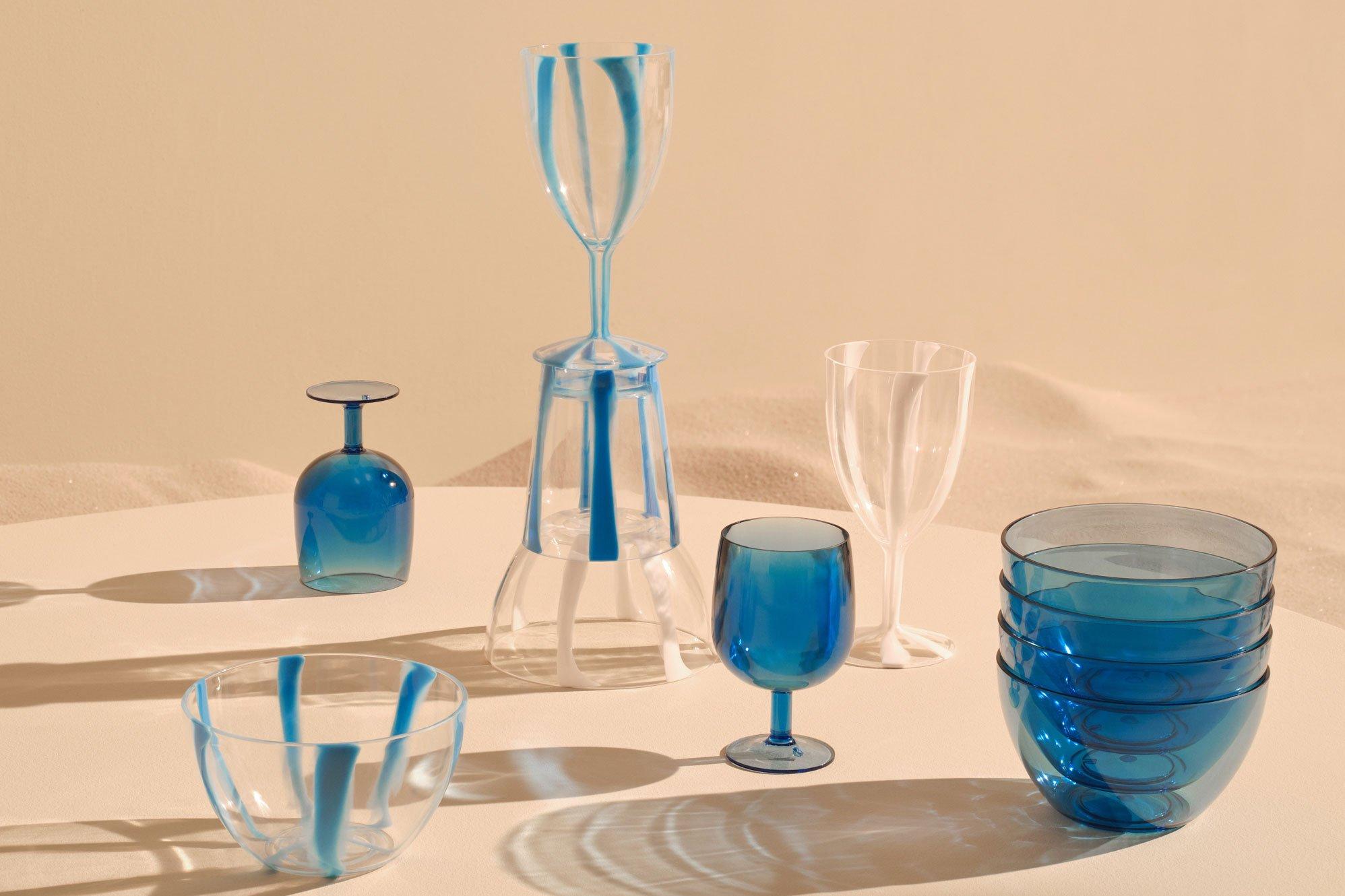 lots of blue plastic glassware on a beige background