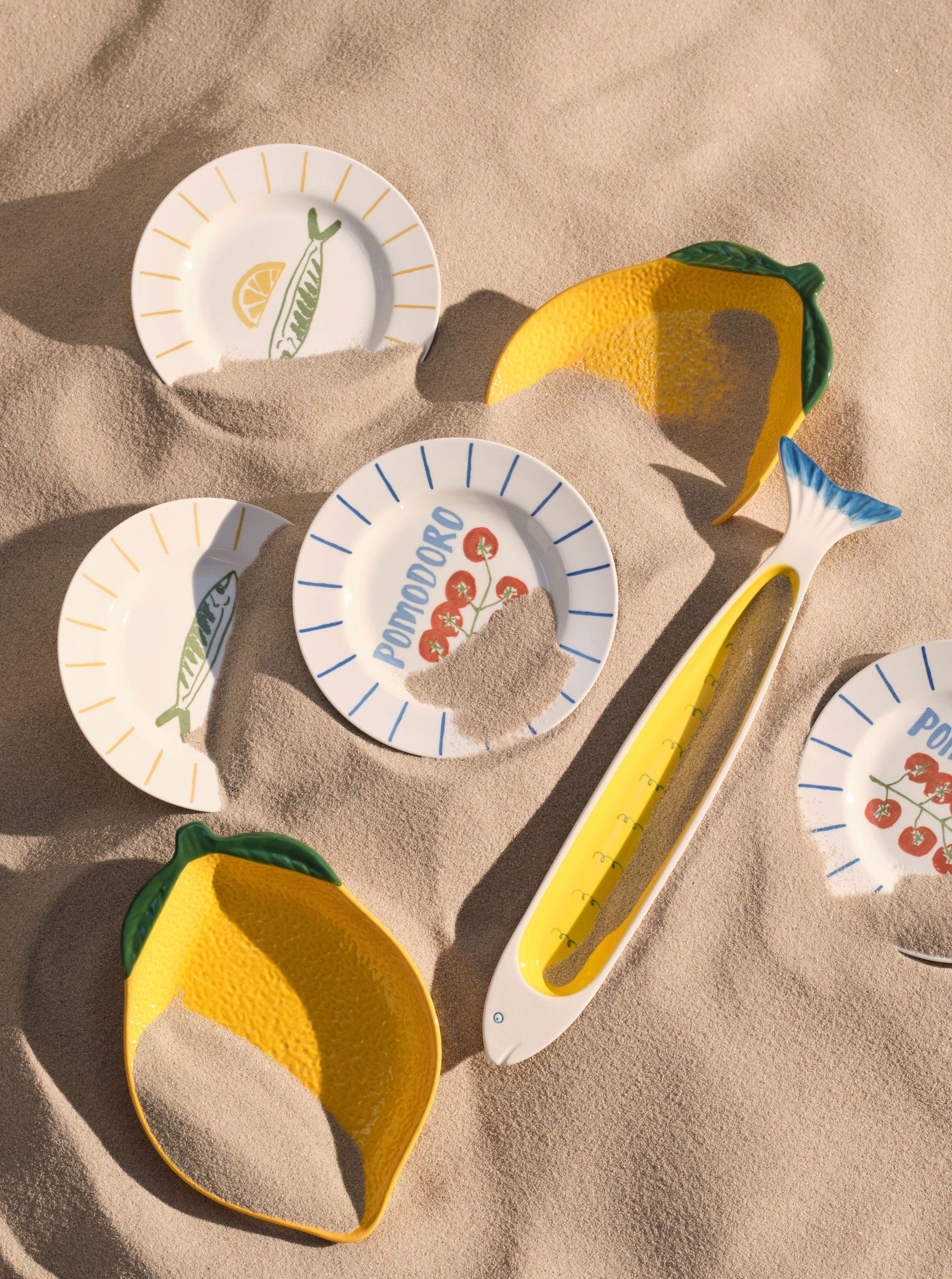 plates on the sand, some buried