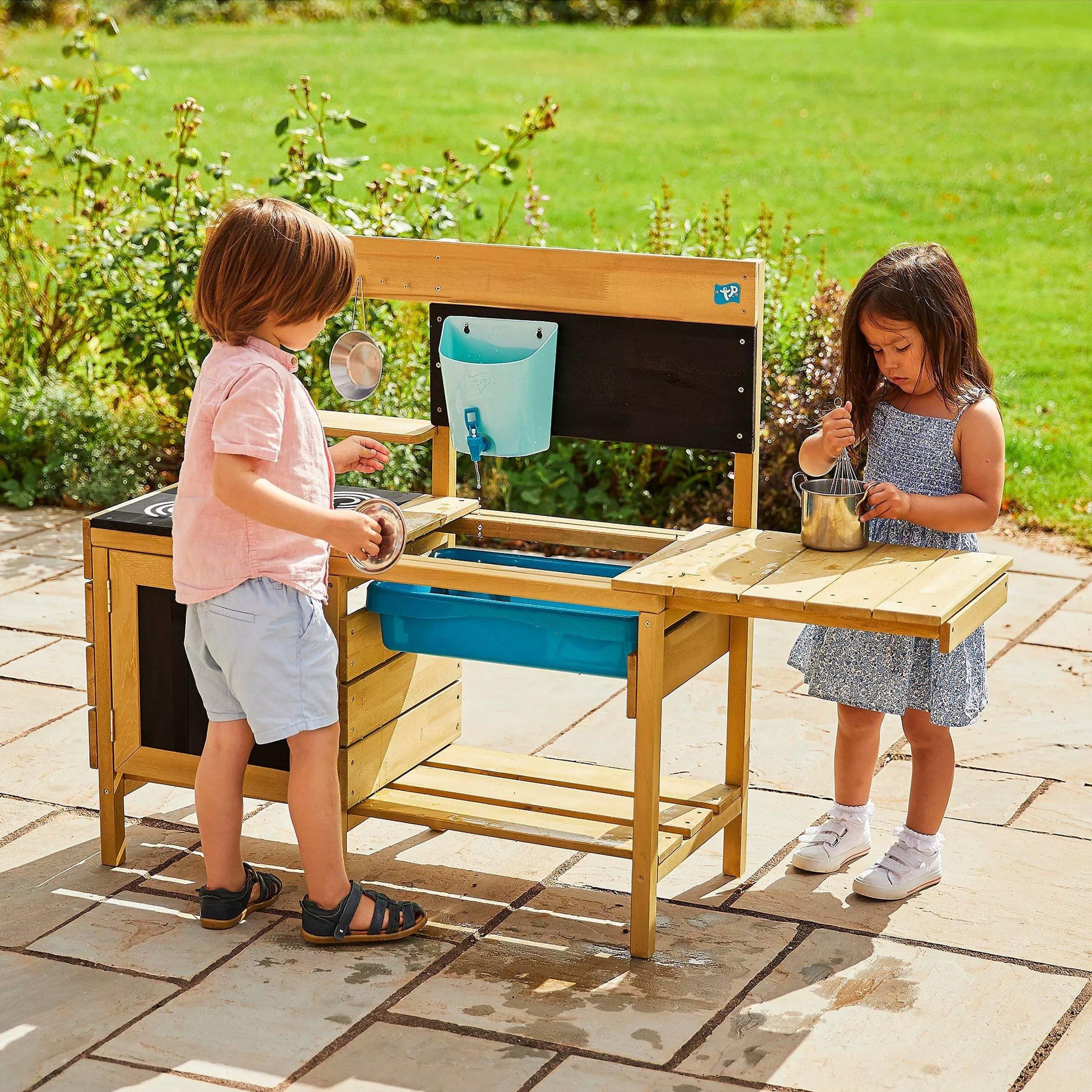 Boy and girl playing with a sand pit water table