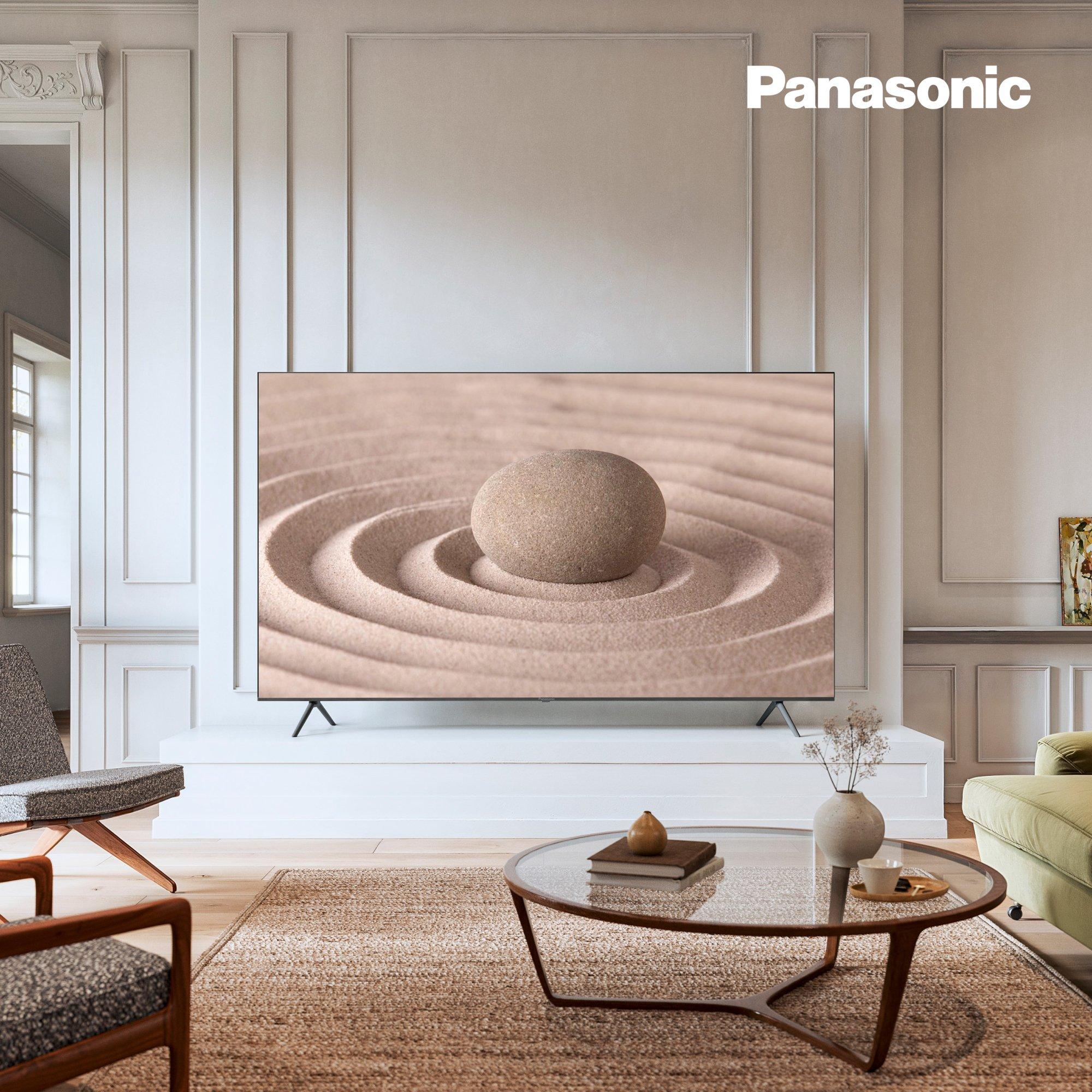 Panasonic TV displayed in a modern, minimal living room with a nature-inspired image on screen.