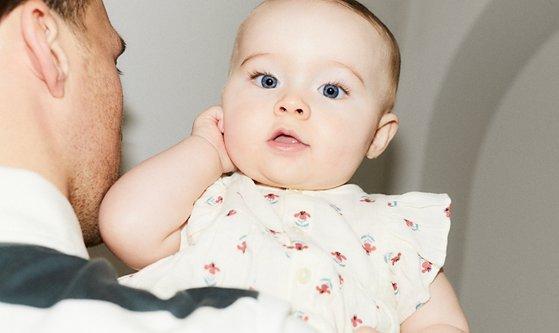 Image of a baby in the arms of their dad