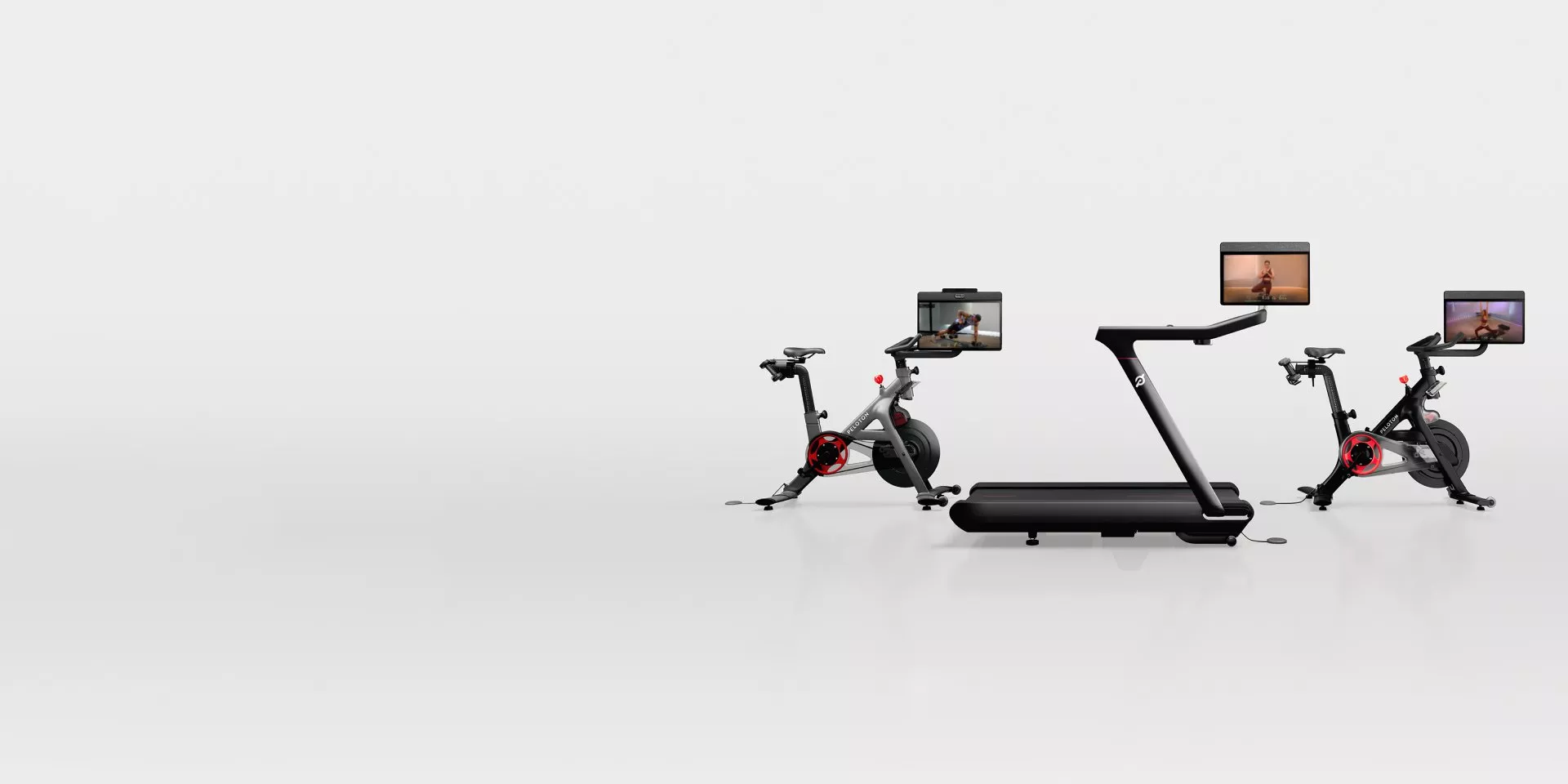 Three Peloton Cross Training Series bikes on a grey background
