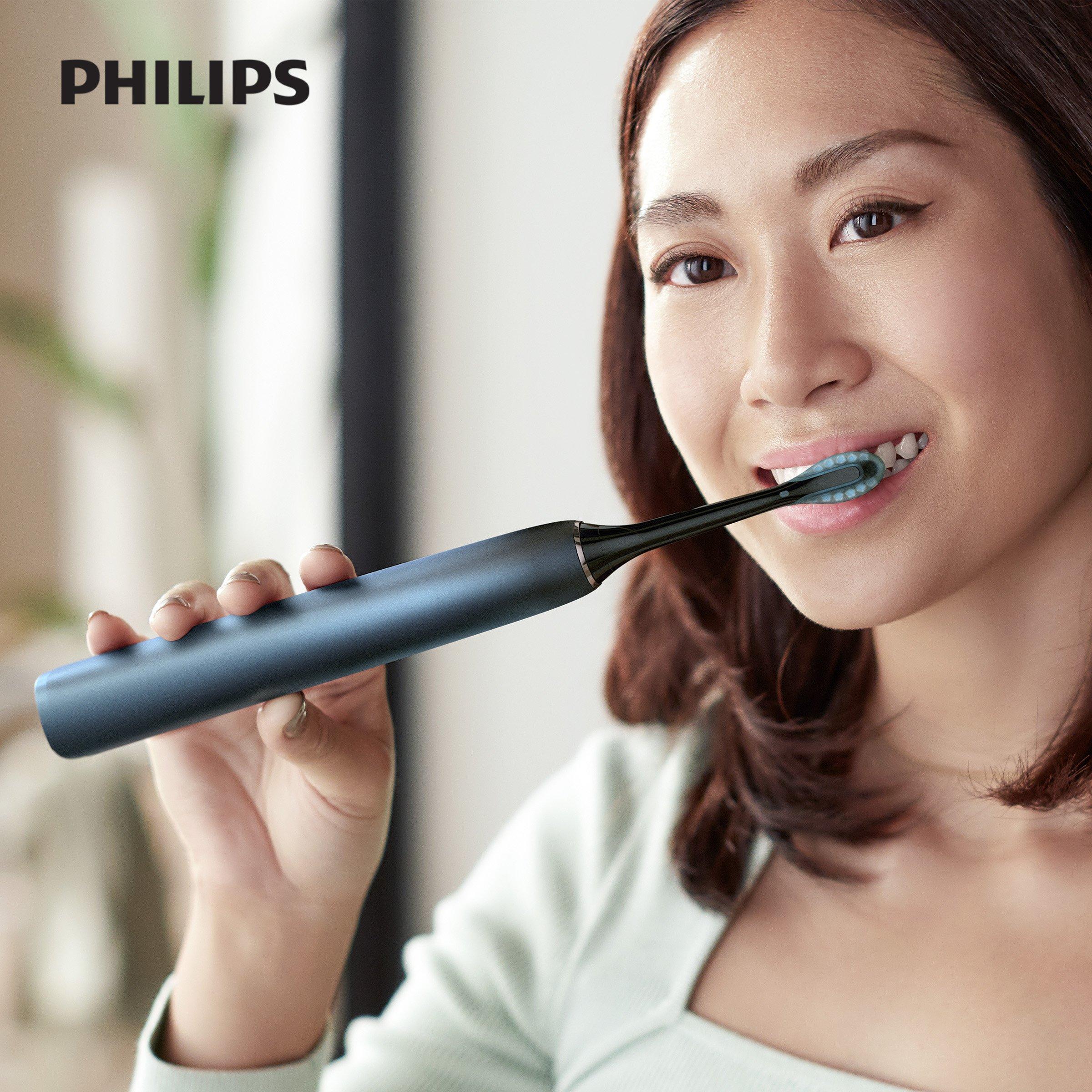 women brushing teeth with philips sonicare diamondclean 9000 a electric-toothbrush