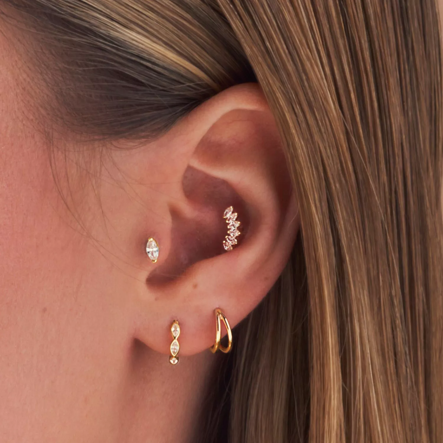 lady wearing 4 ear piercings