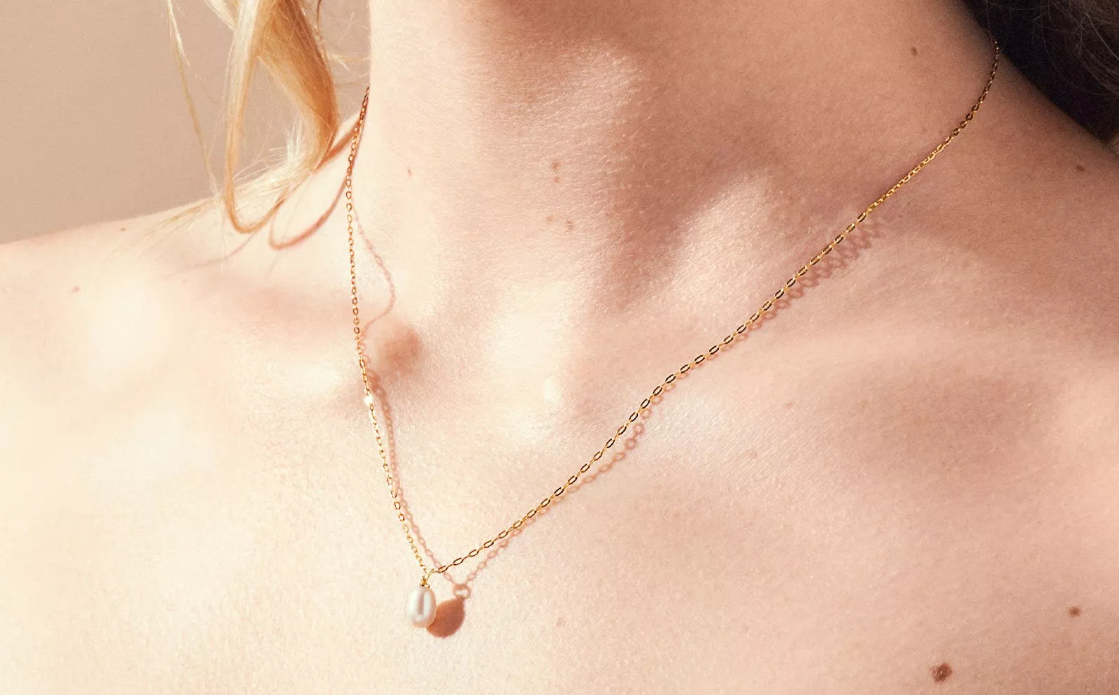 lady wearing gold pendant necklace