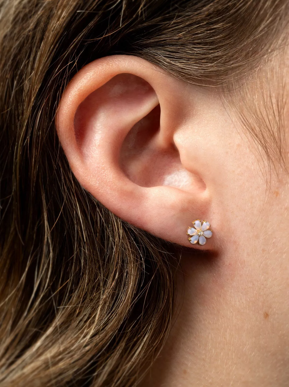 girl wearing white flower earring