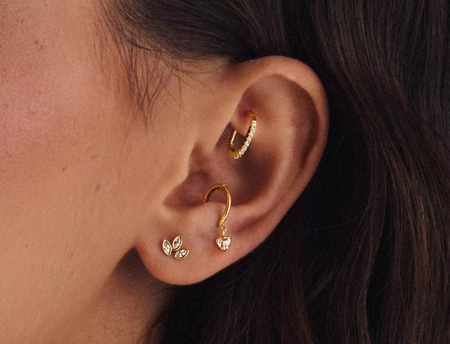 lady wearing three earrings 